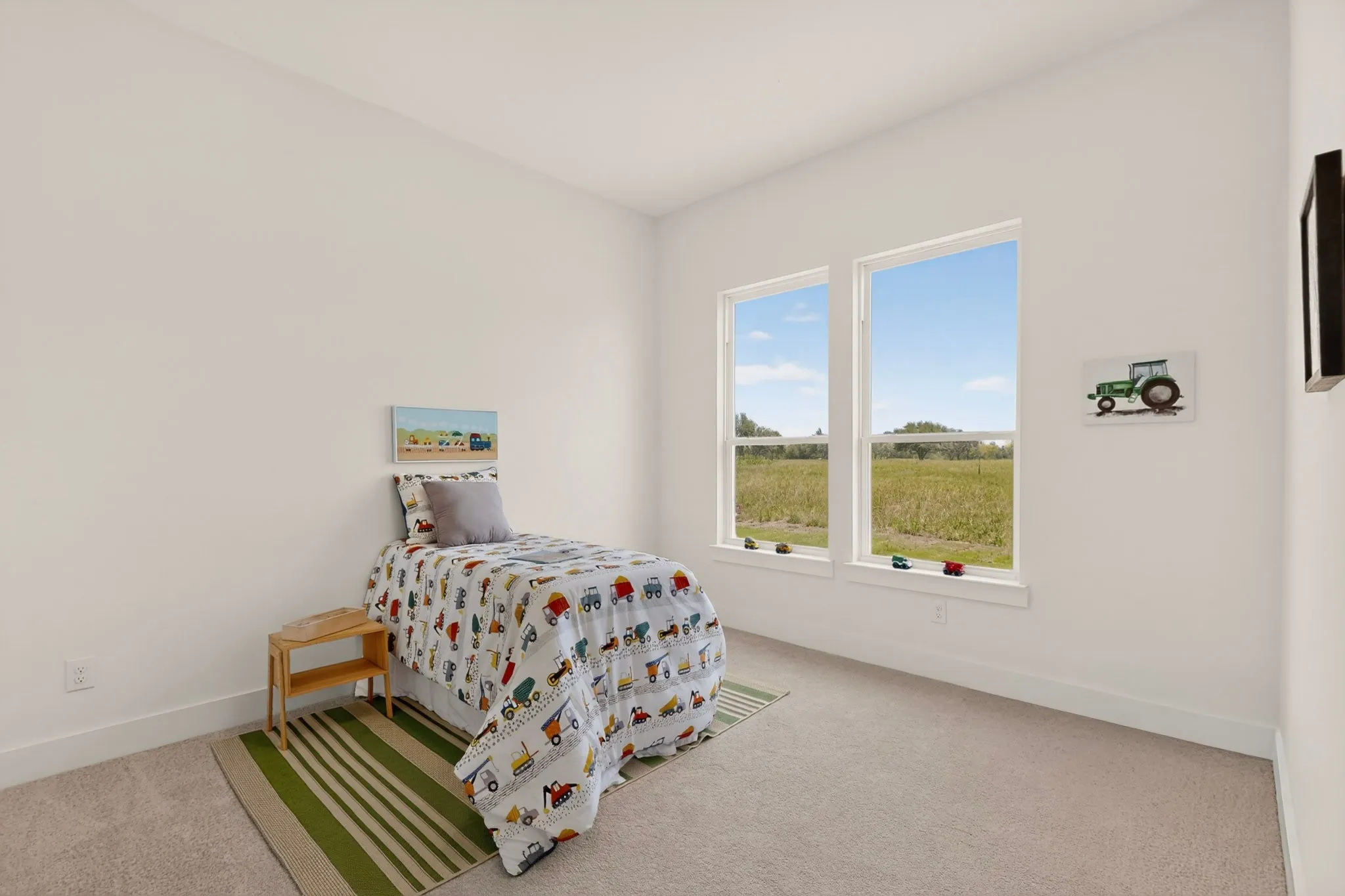Neutral wall finishes with dual windows overlooking an expansive field