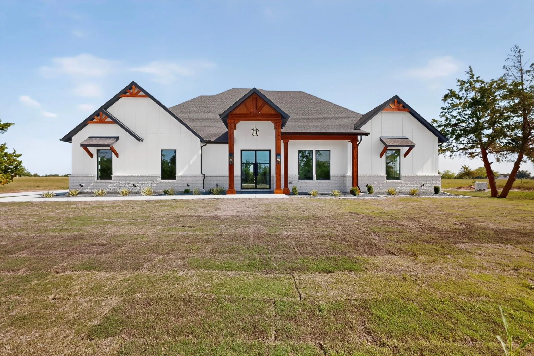 Contemporary single-story residence with a white board-and-batten and stone facade