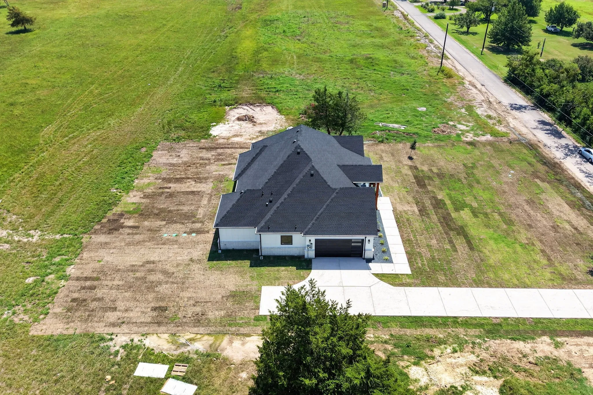 Contemporary single-story residence featuring a dark shingle roof and white siding