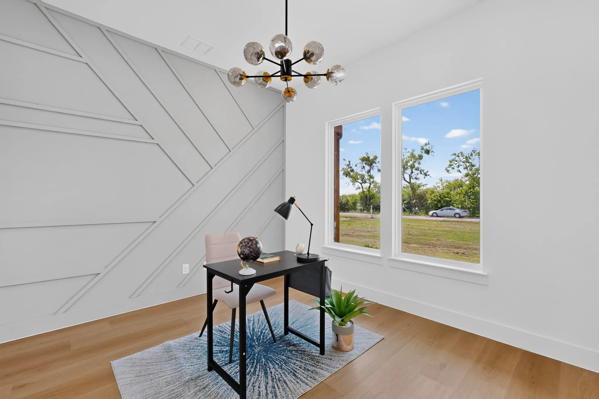 Feature wall with geometric paneling complemented by light wood-finish flooring