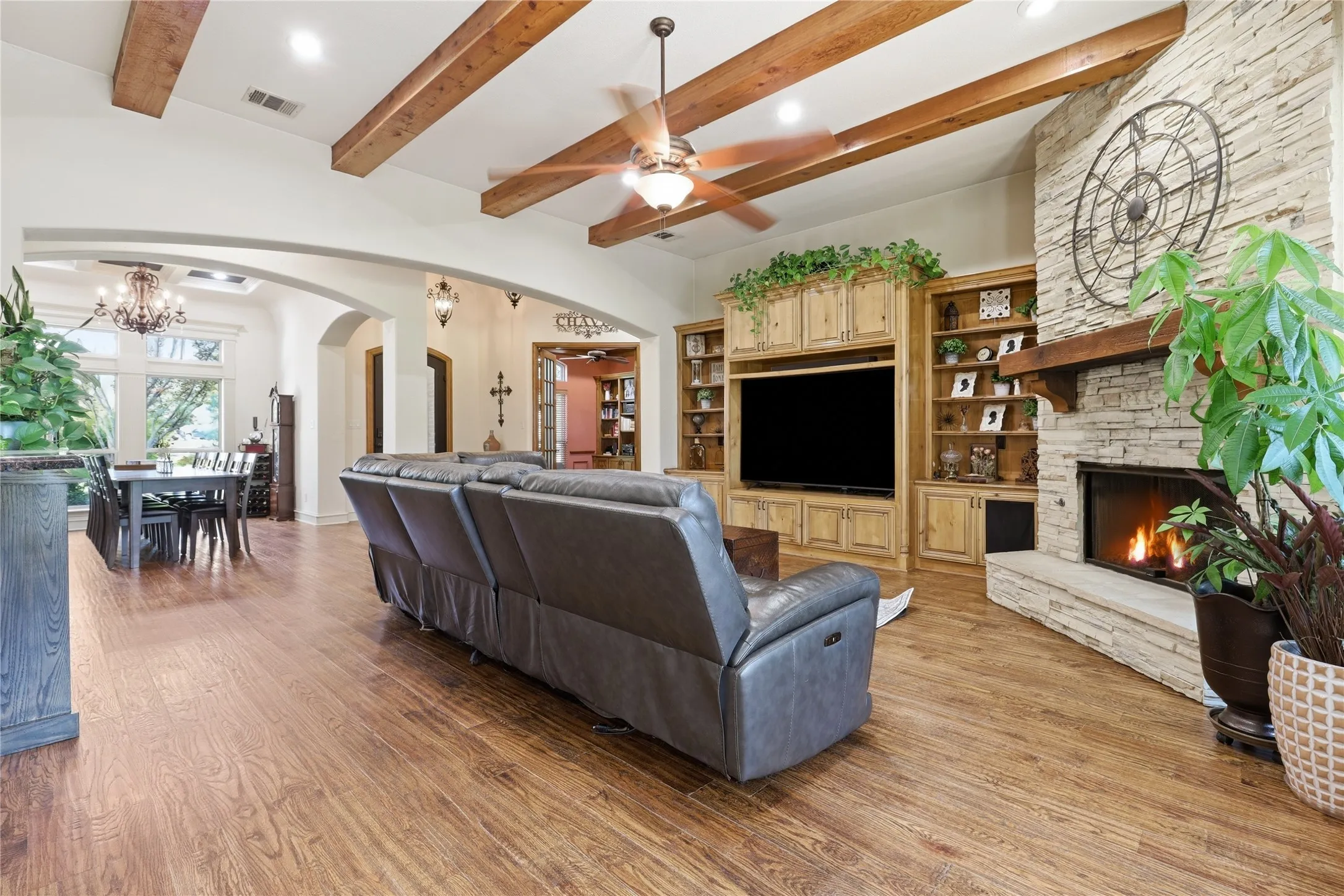 Living area with exposed wood ceiling beams and wood-finish flooring