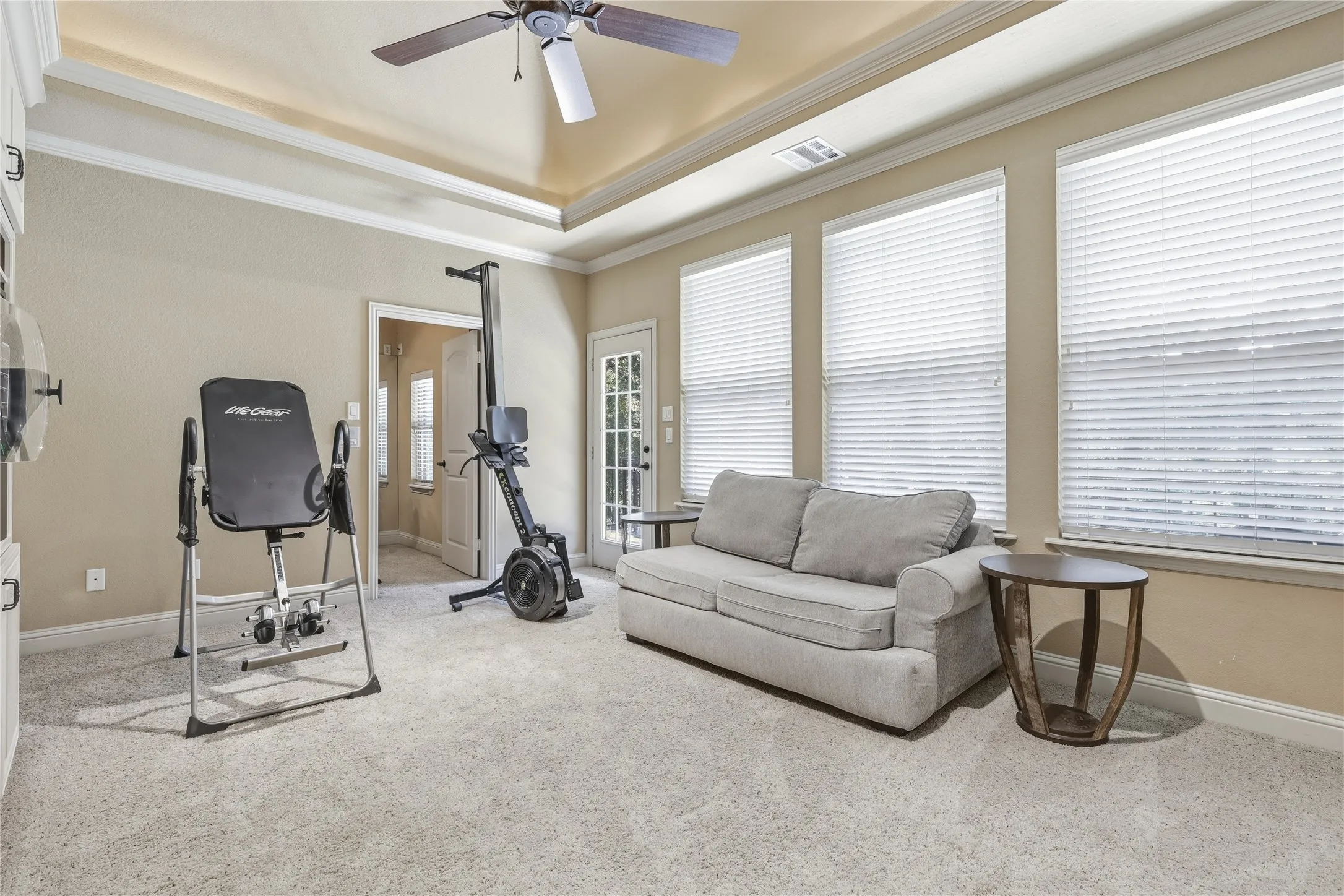 Living room leading to bonus room and balcony