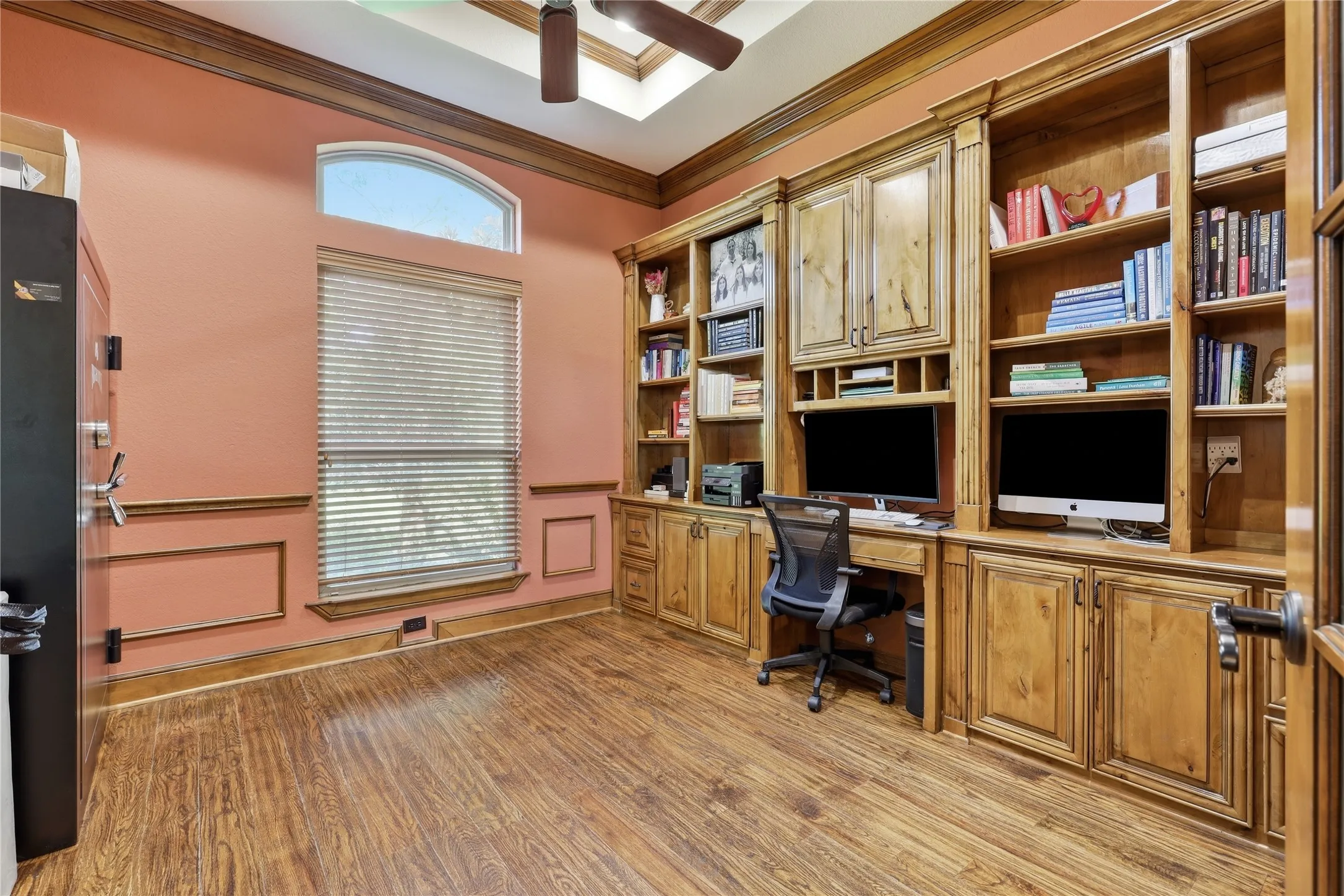 Built-in wood cabinetry and shelving units provide extensive storage and display space