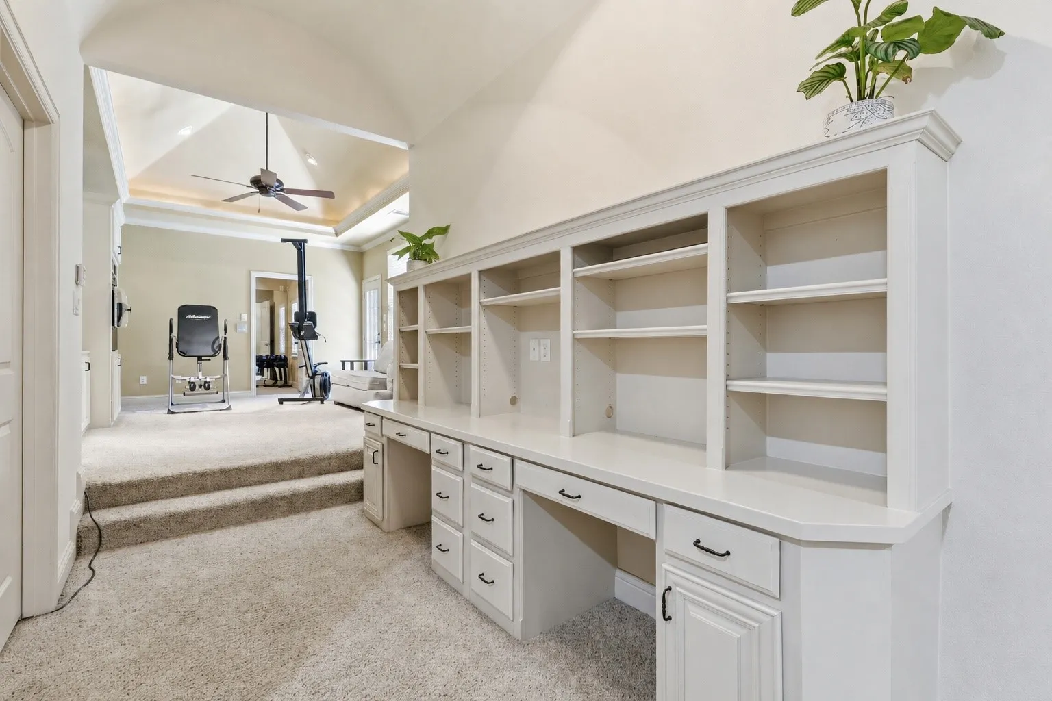 Built-in desk with extensive cabinetry and open shelving