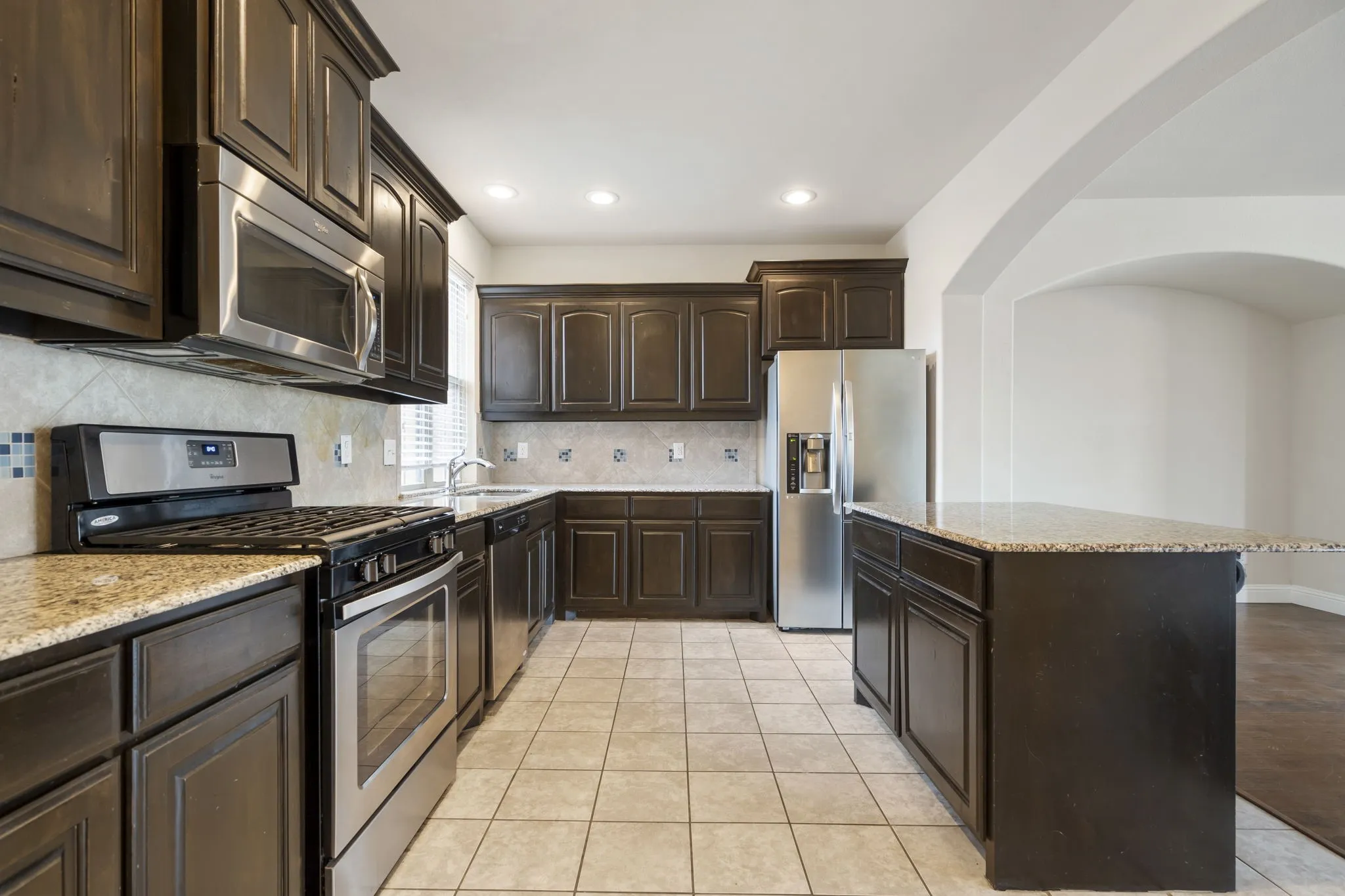The kitchen has stainless appliances and comes with the refrigerator