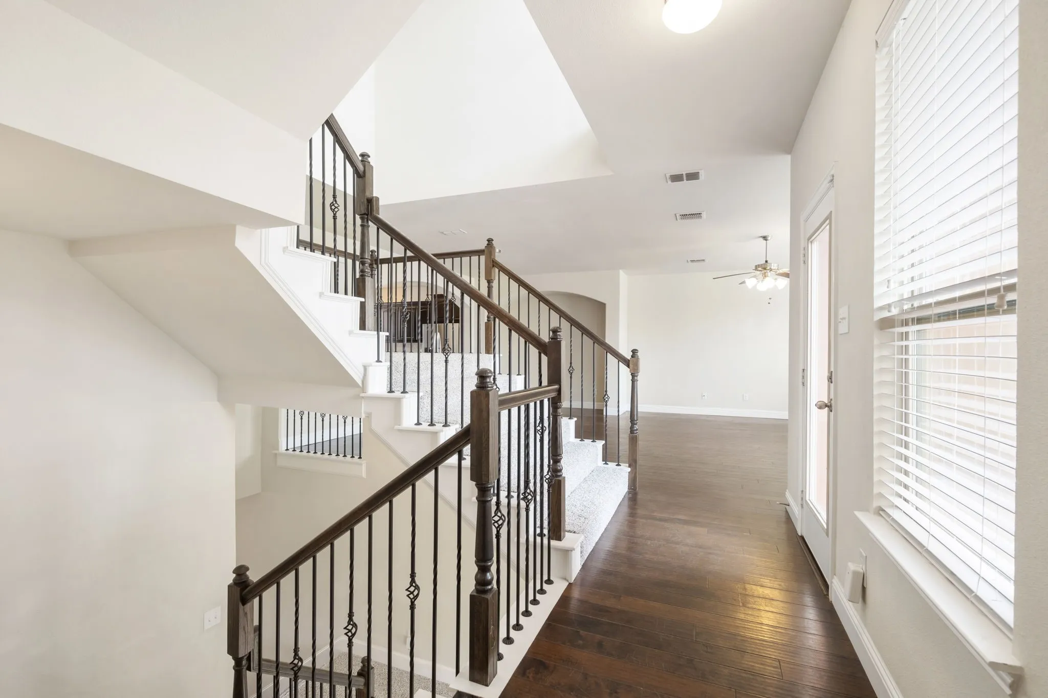 This is the stair landing on the second floor.  The balcony access is the door to the right.