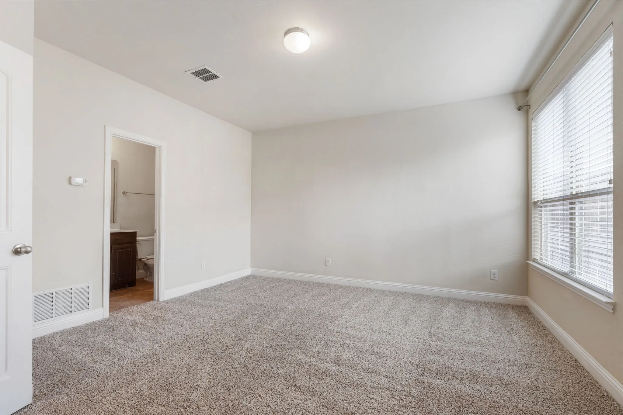 The spacious bedroom on the first floor is private and has its own attached bathroom.