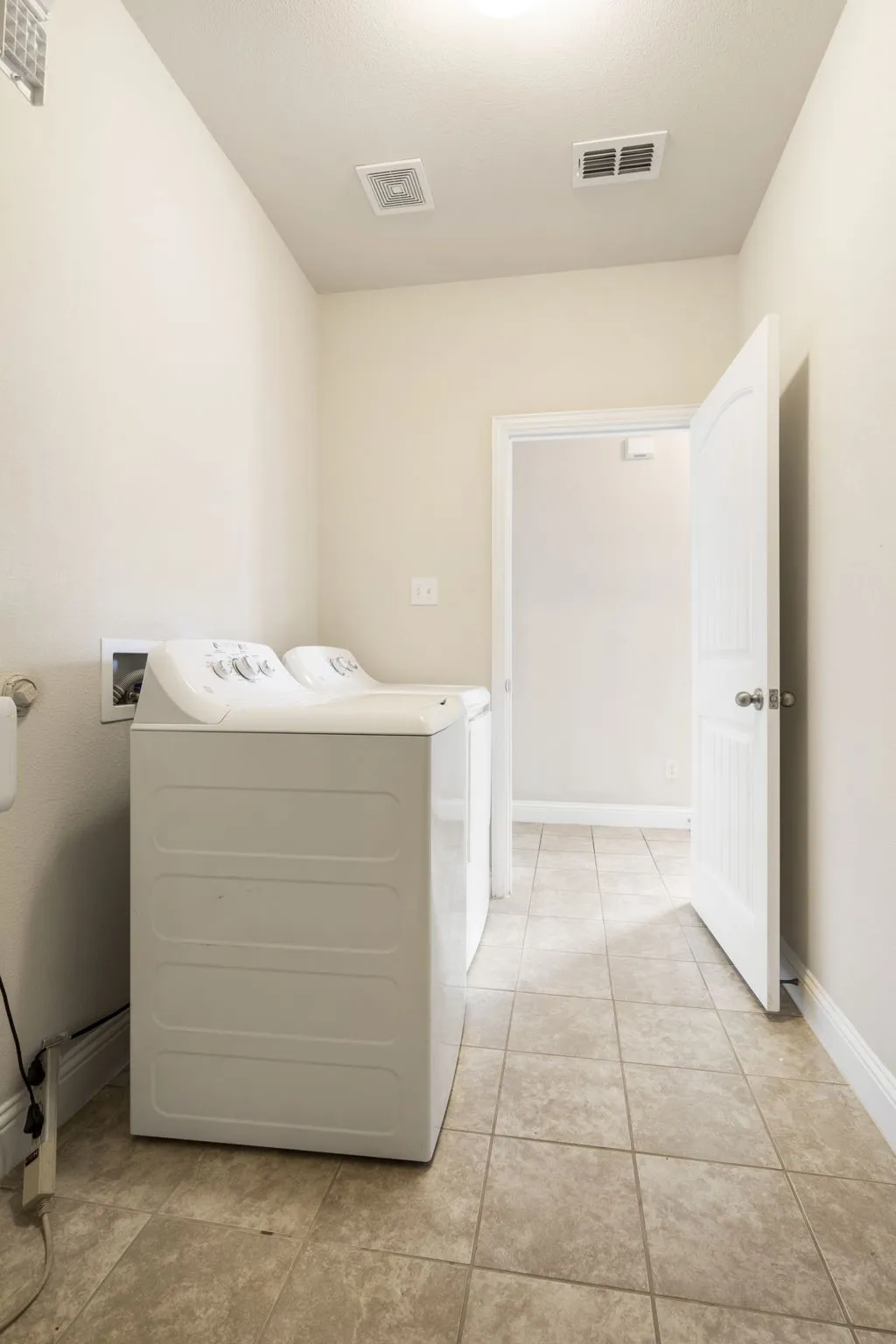 The laundry room is connected to the attached garage and comes with a washer and dryer.