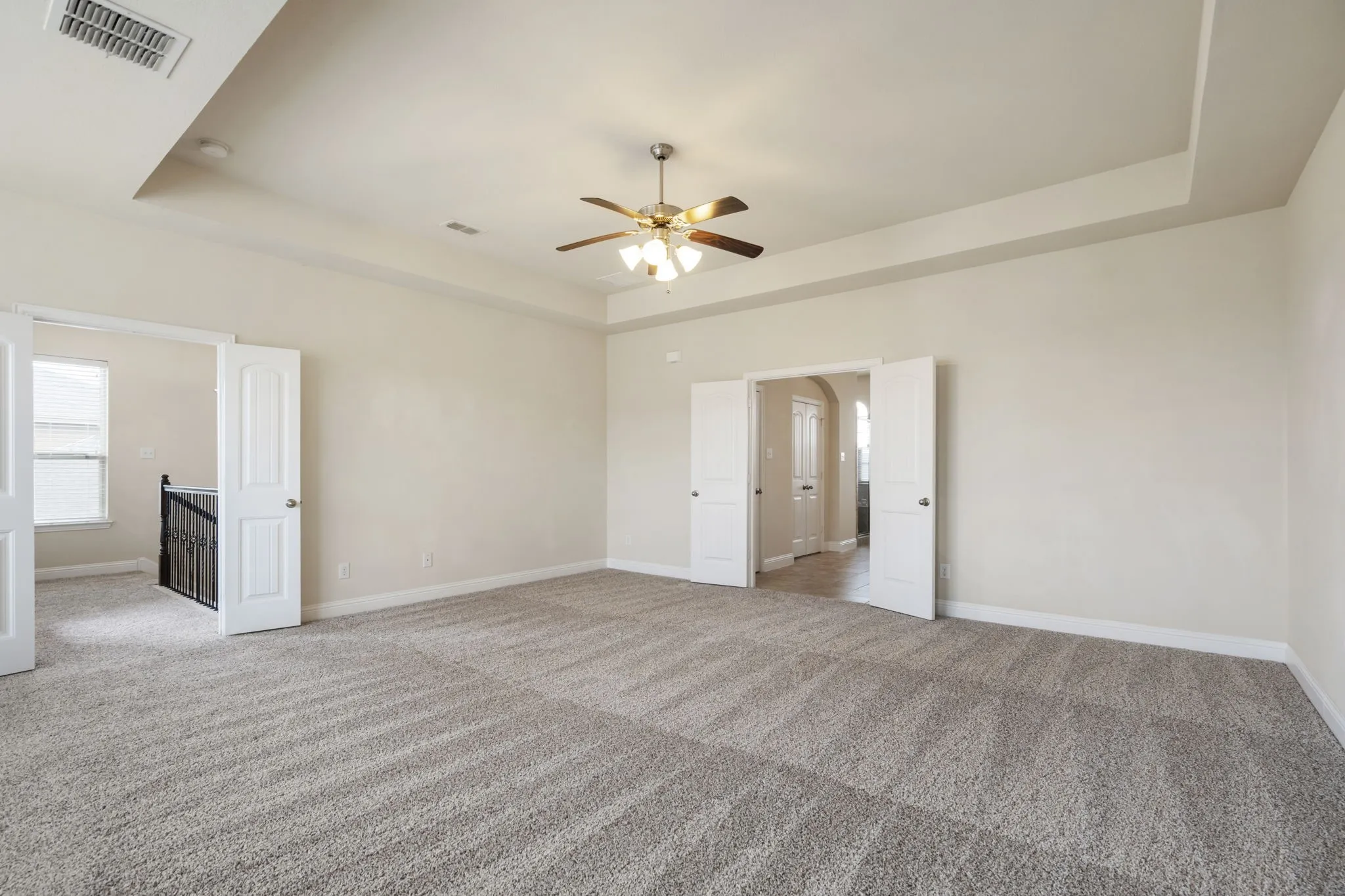 The primary bedroom has double doors leading into it as well as into the bathroom.