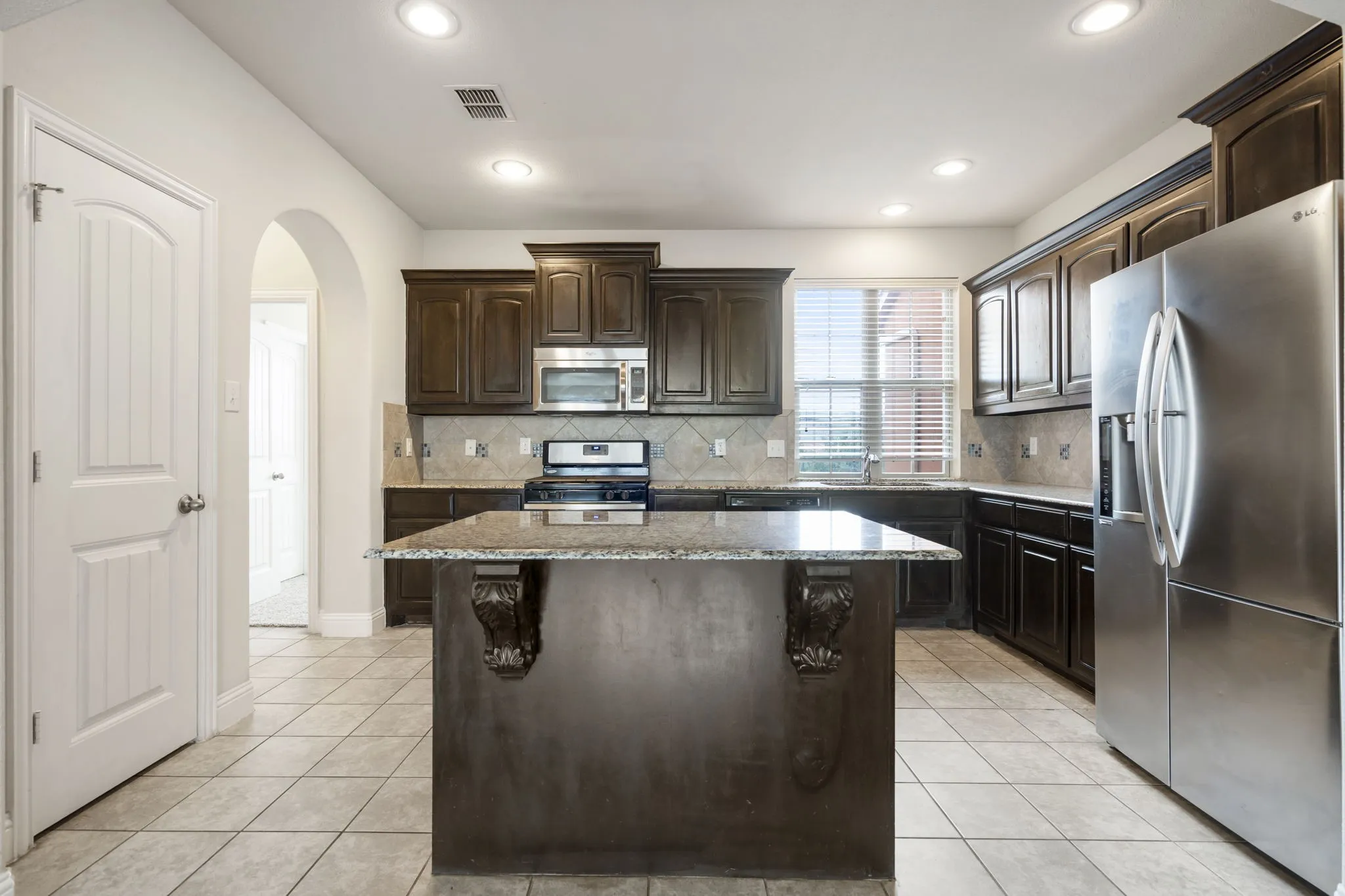 The kitchen has a pantry and island.  The bathroom and 2nd floor bedroom is through the opening to the left.