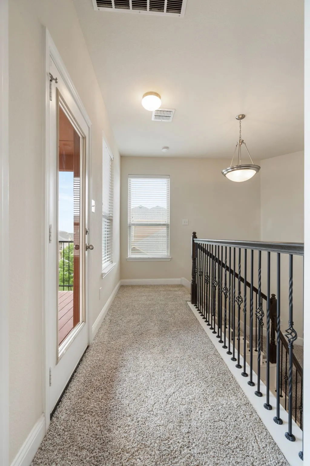 The landing outside the primary suite has access to another balcony!