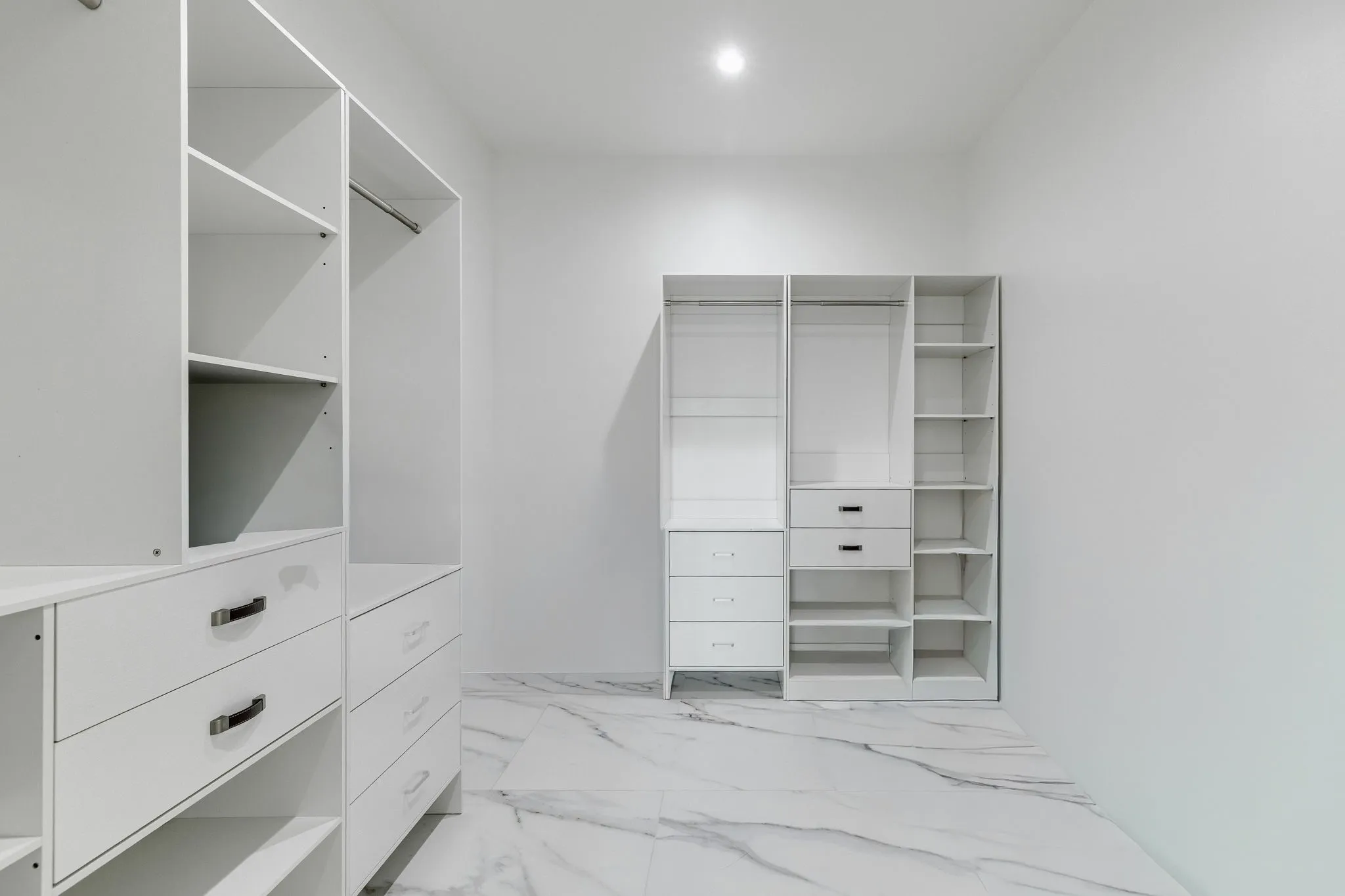 White custom closet system featuring integrated shelving and drawer units