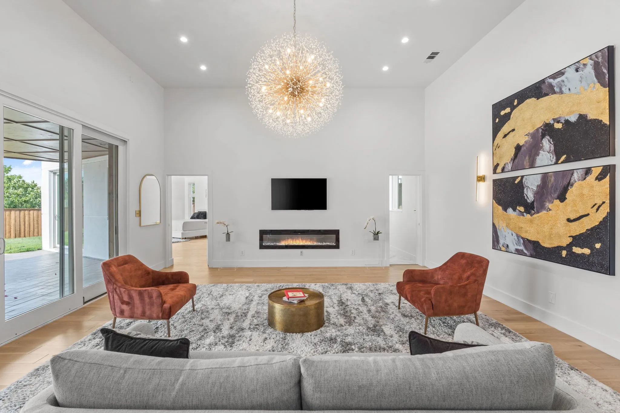Vaulted ceiling living space with light wood-finish flooring