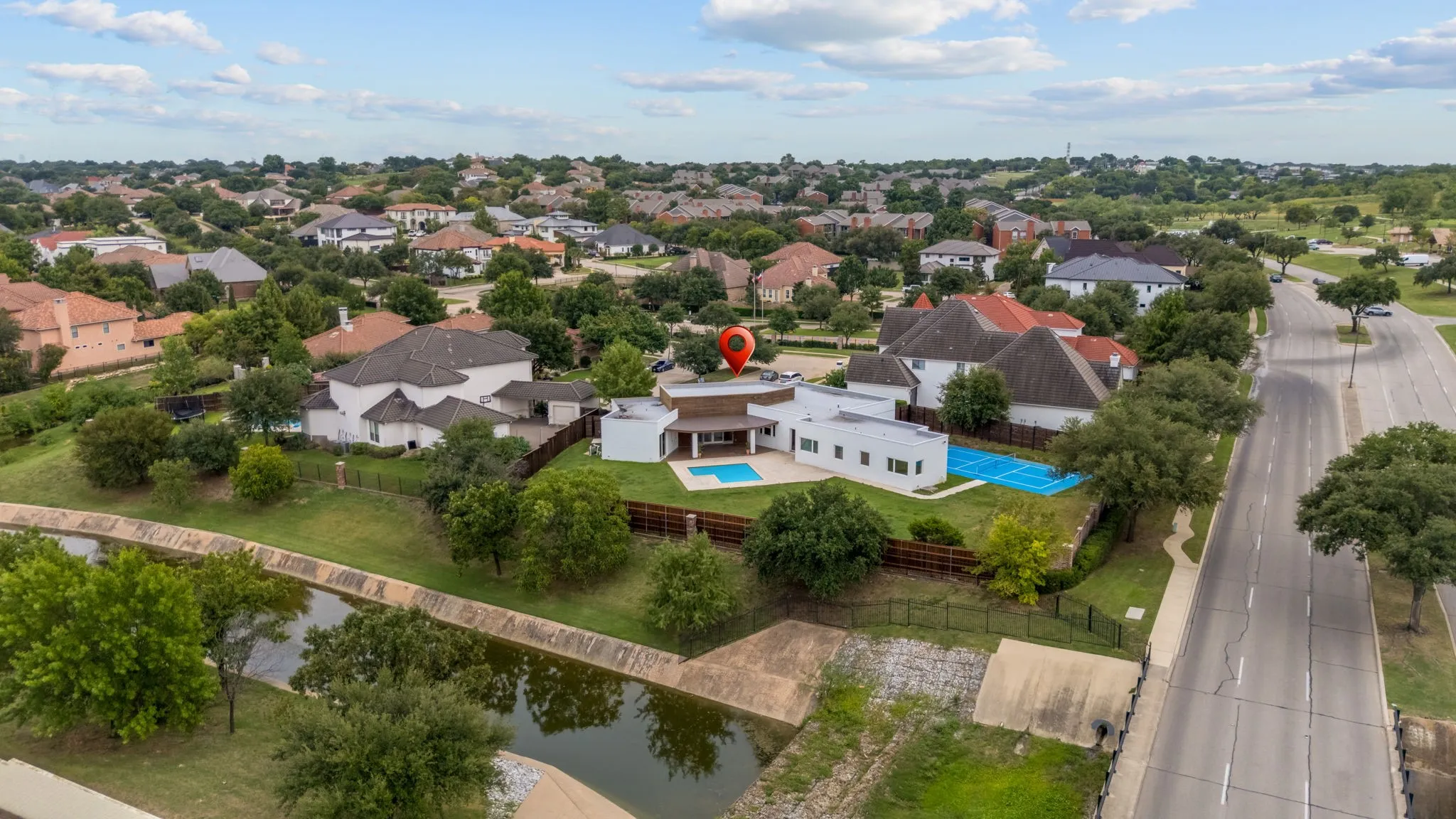 Contemporary residence featuring a private pool, sport court, and a multi-level design