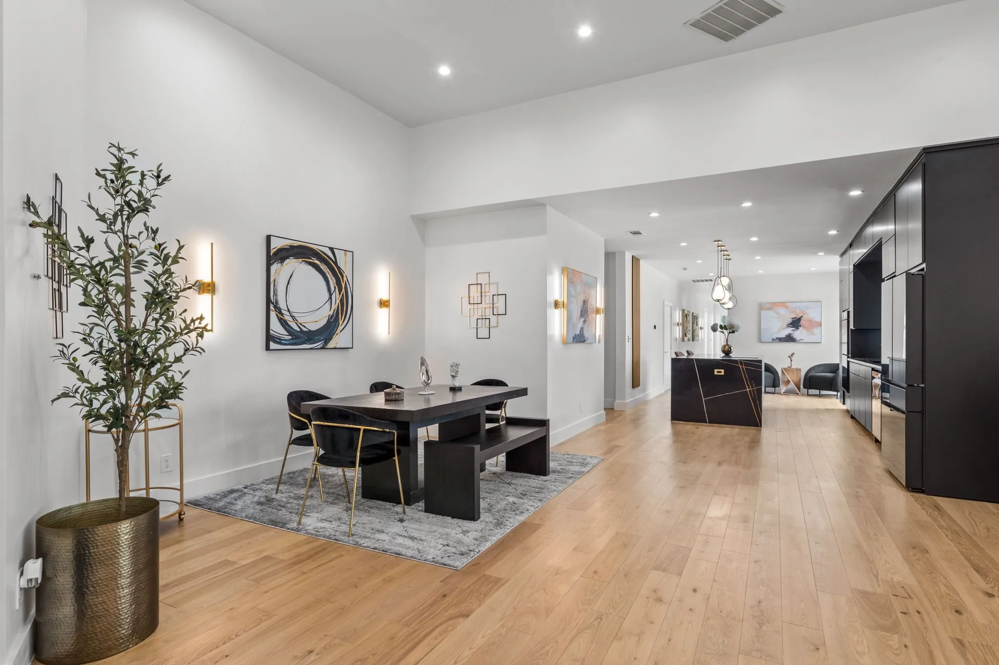 Open-concept living space featuring wood-finish flooring, recessed lighting, and white walls