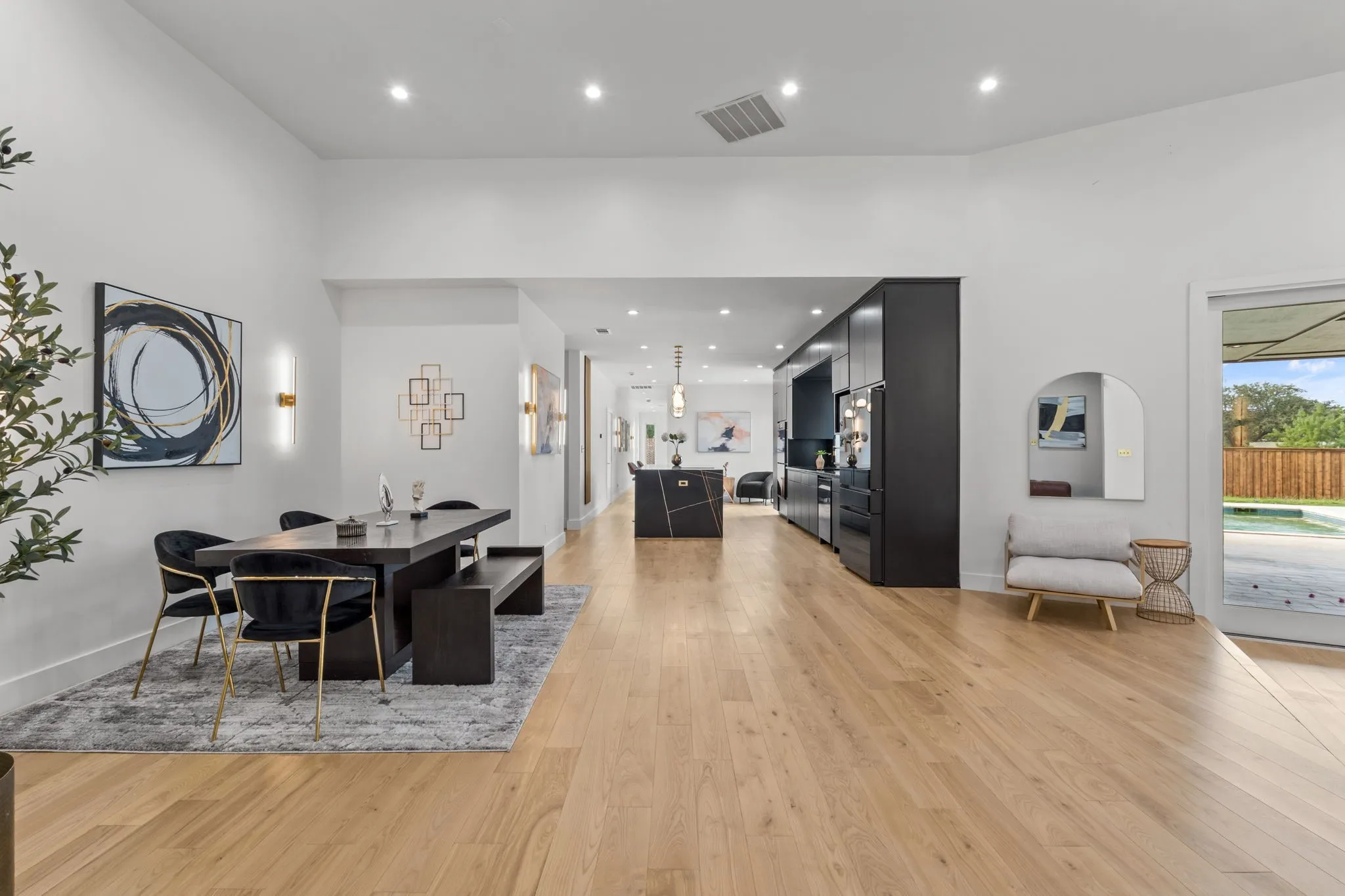 Spacious interior featuring light wood-finish flooring, recessed lighting, and white walls