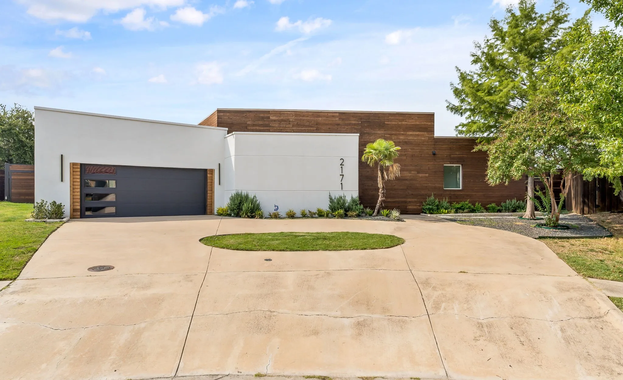 Modern architectural exterior with a white facade and wood-paneled accents