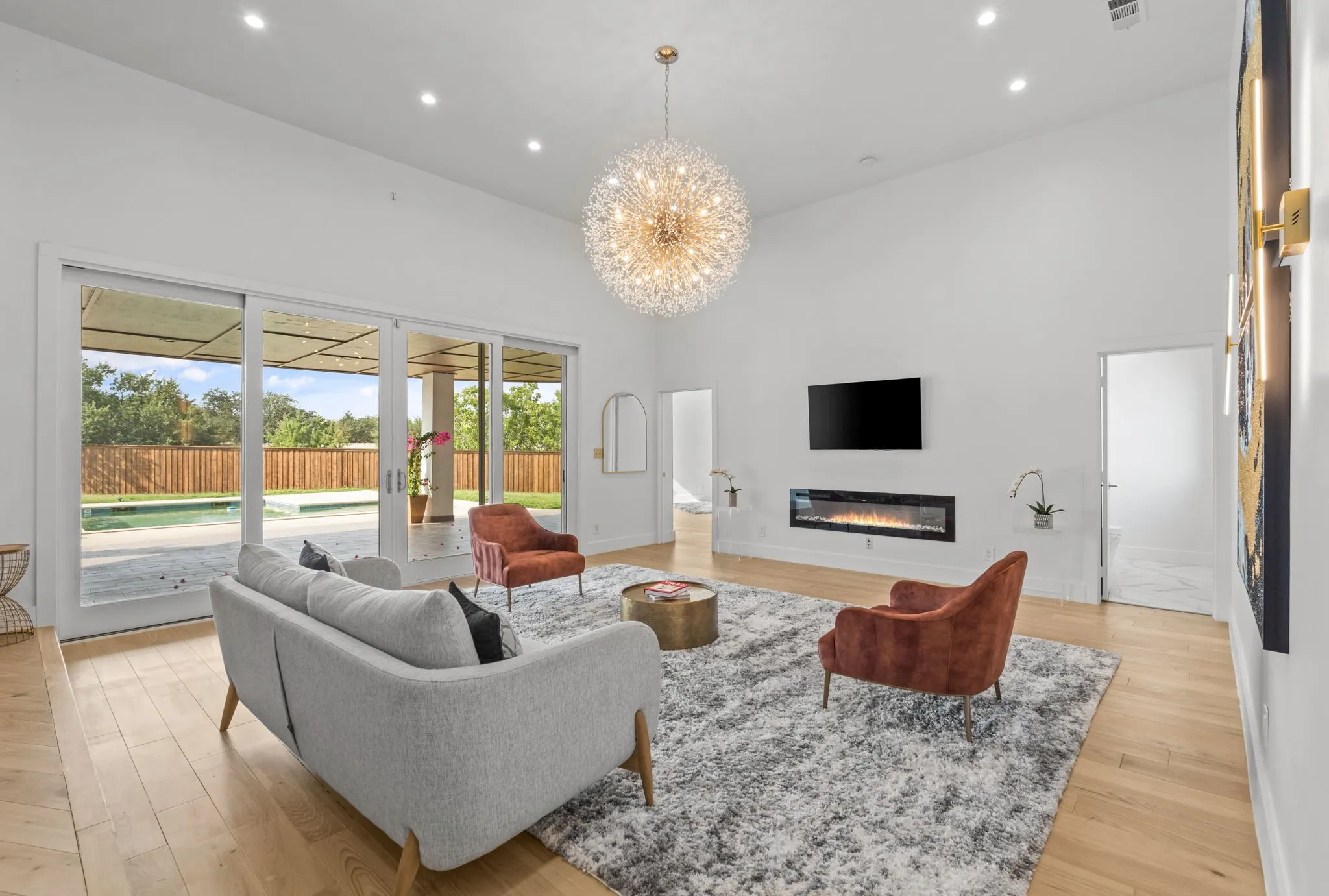Living area with vaulted ceilings, recessed lighting, and light wood-finish flooring