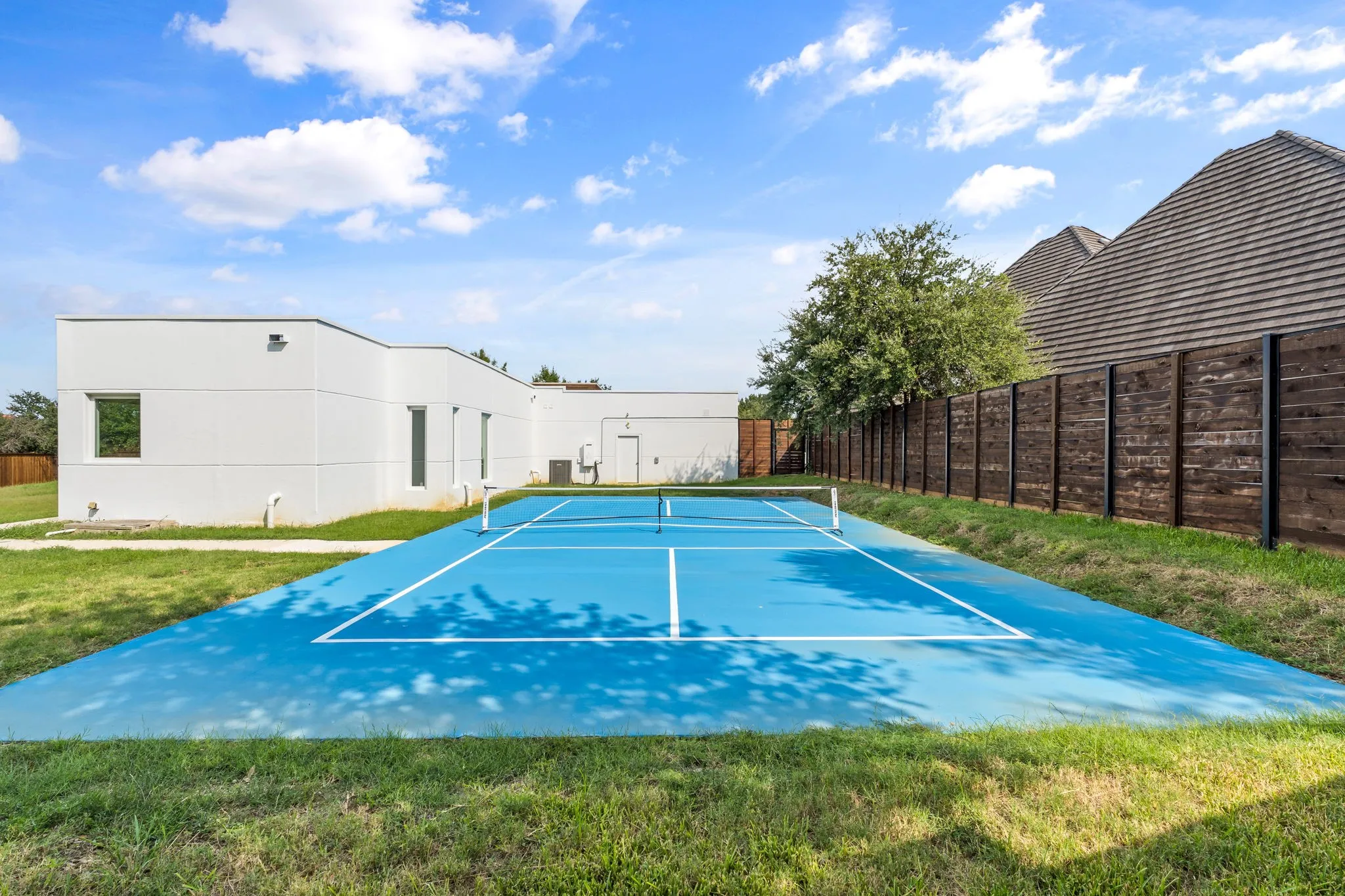 Blue sport court with white line markings and net