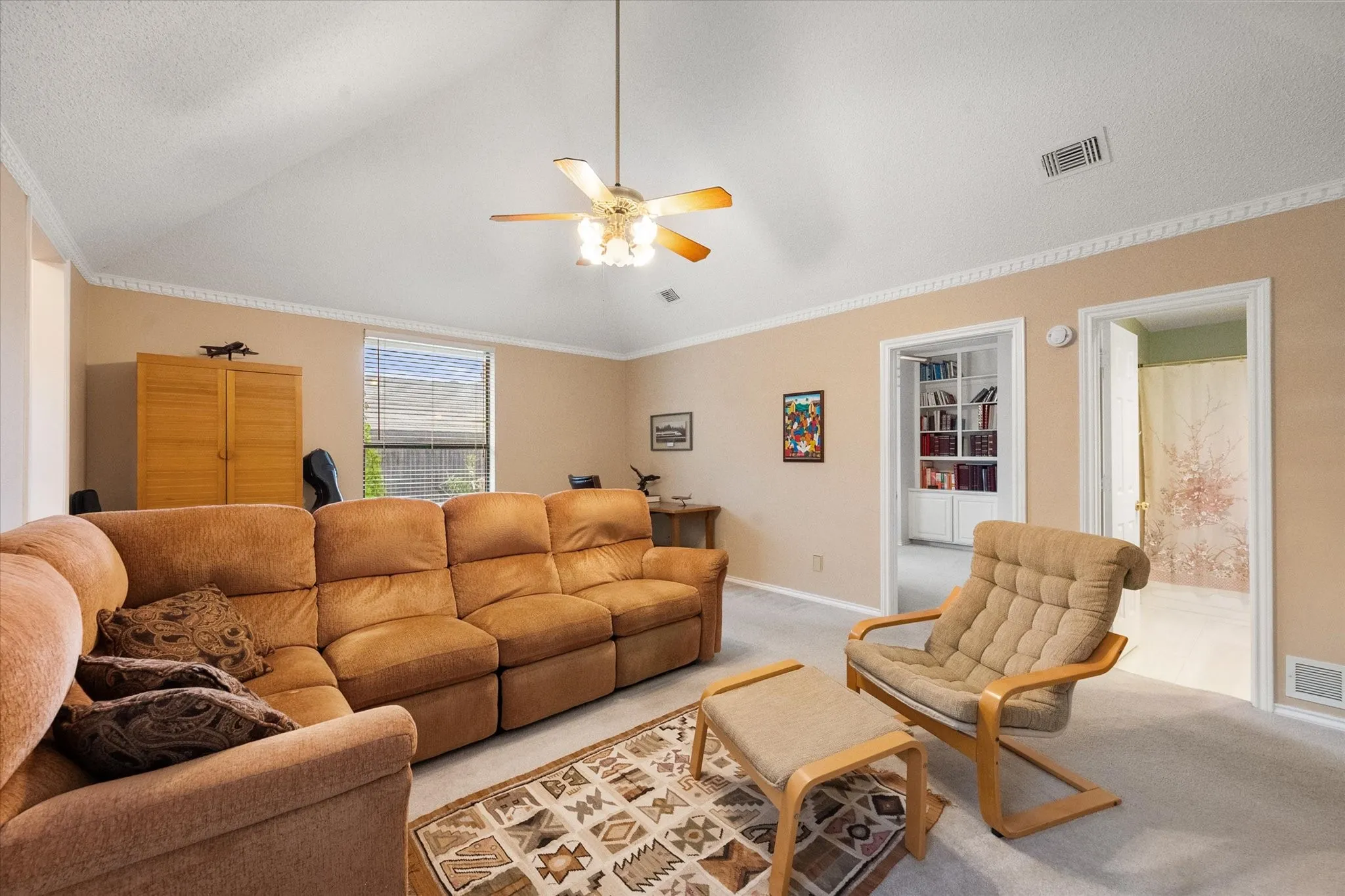 Vaulted ceiling featuring a ceiling fan with light fixture