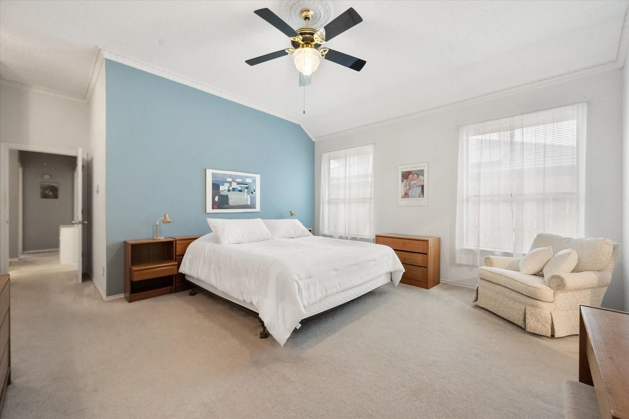 Spacious primary room with vaulted ceilings complementing a two-tone wall design