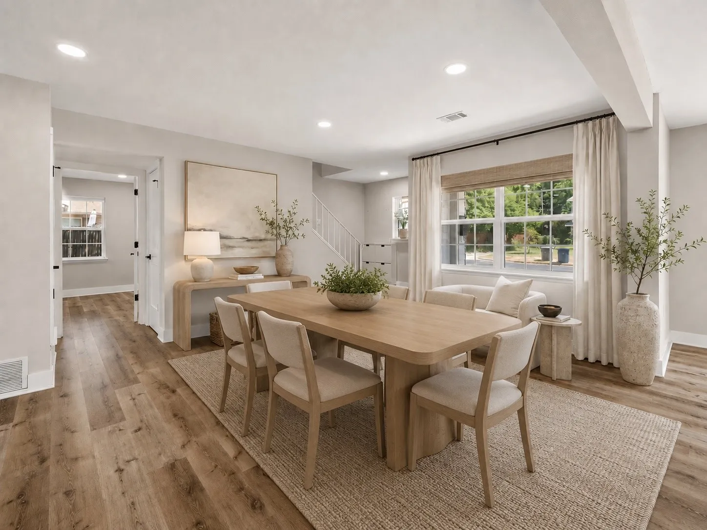 Open-concept common area featuring wood-finish flooring, recessed lighting, and large windows with natural light