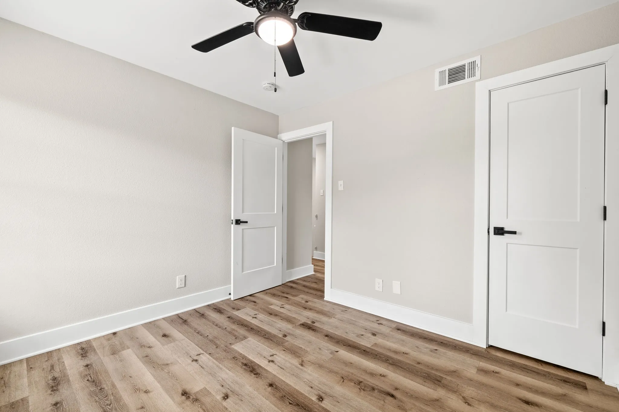 Neutral-toned interior featuring wood-finish flooring