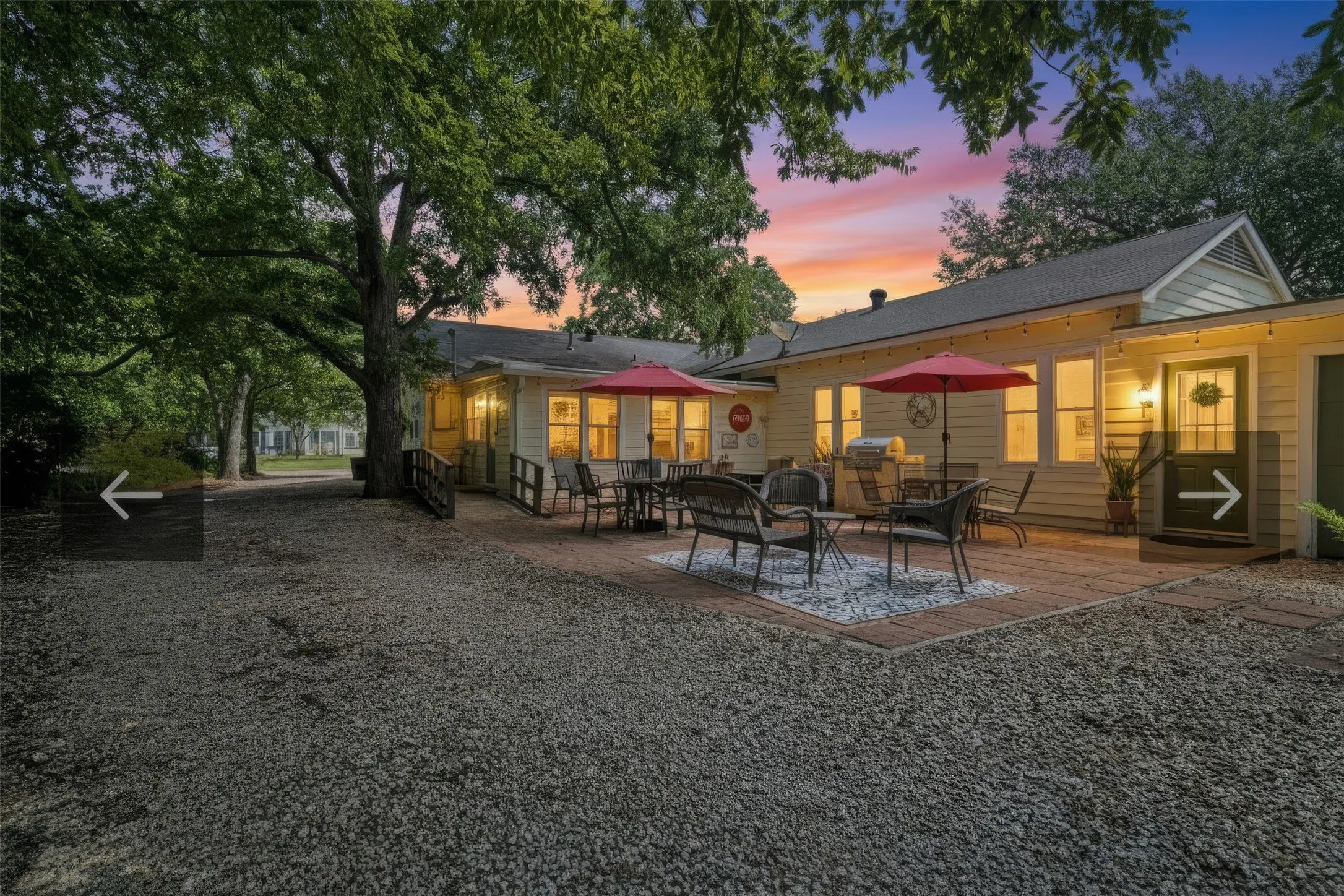 Side of home with outdoor cooking area.  Includes a detached grill and sink that can remain with the home