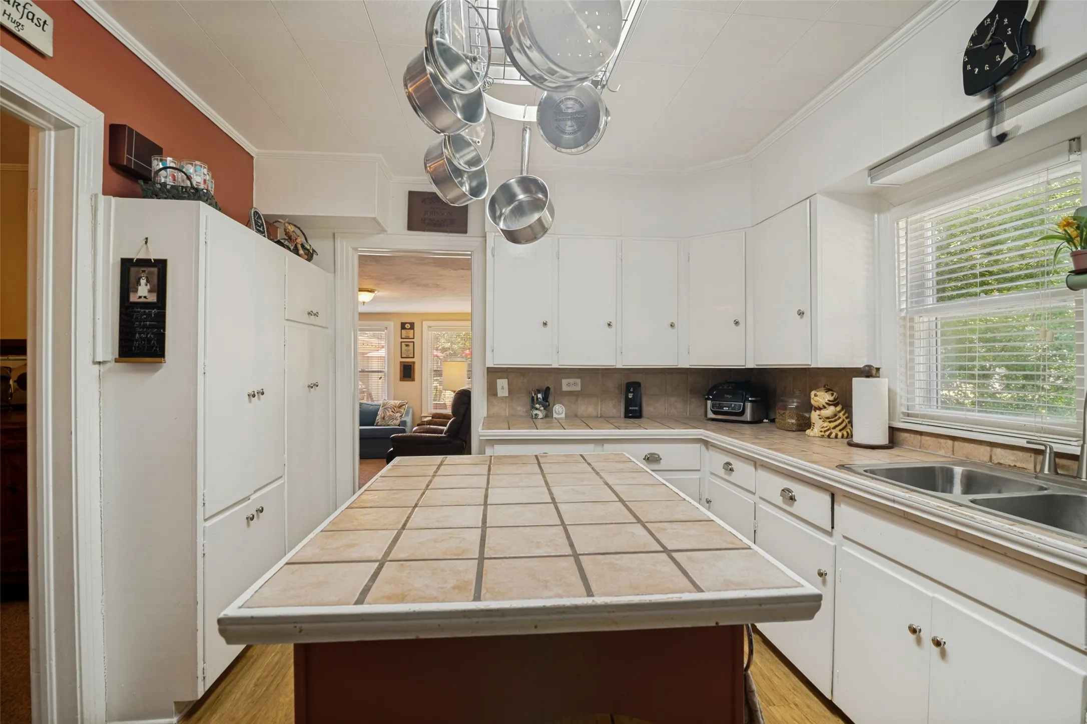 Kitchen with durable tile counters, am island, and ample cabinetry