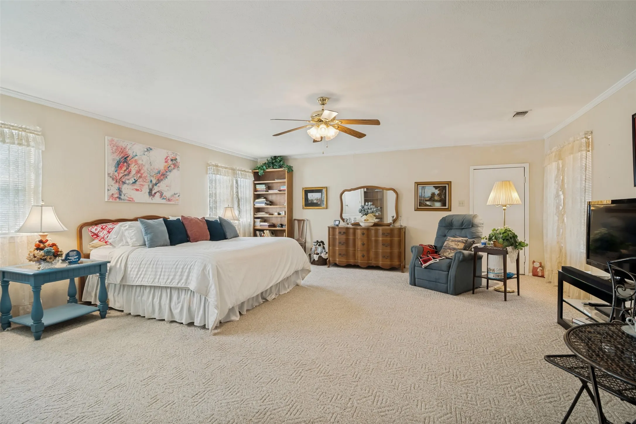 Large primary bedroom with garage entry and three closets