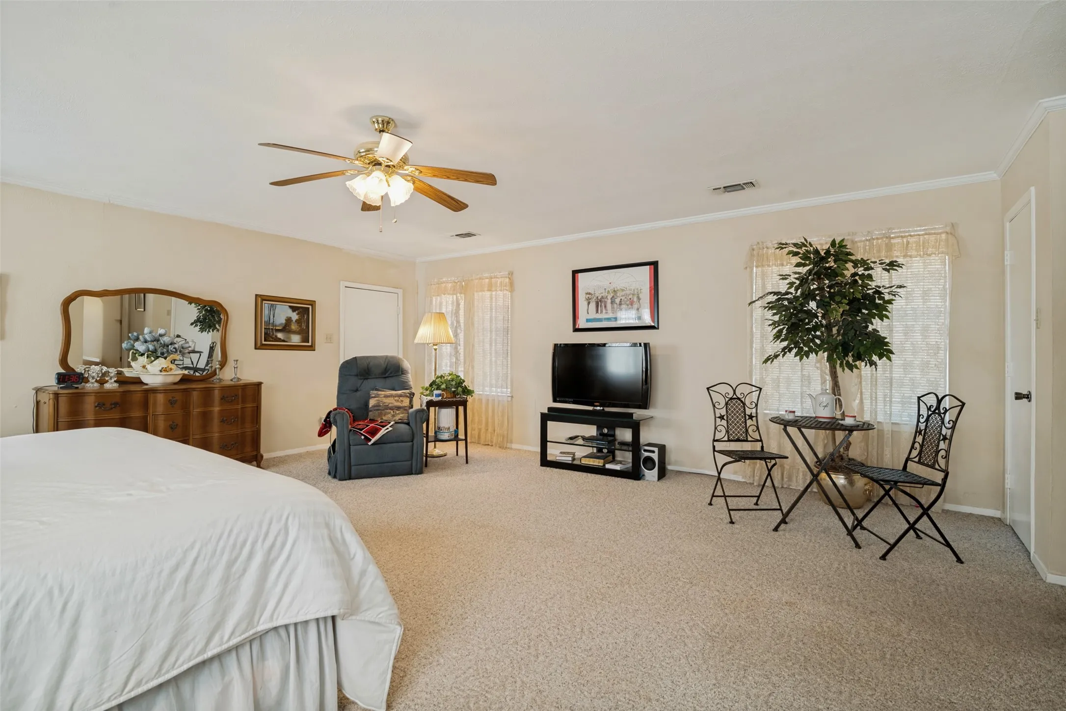 Large primary bedroom with garage entry and three closets