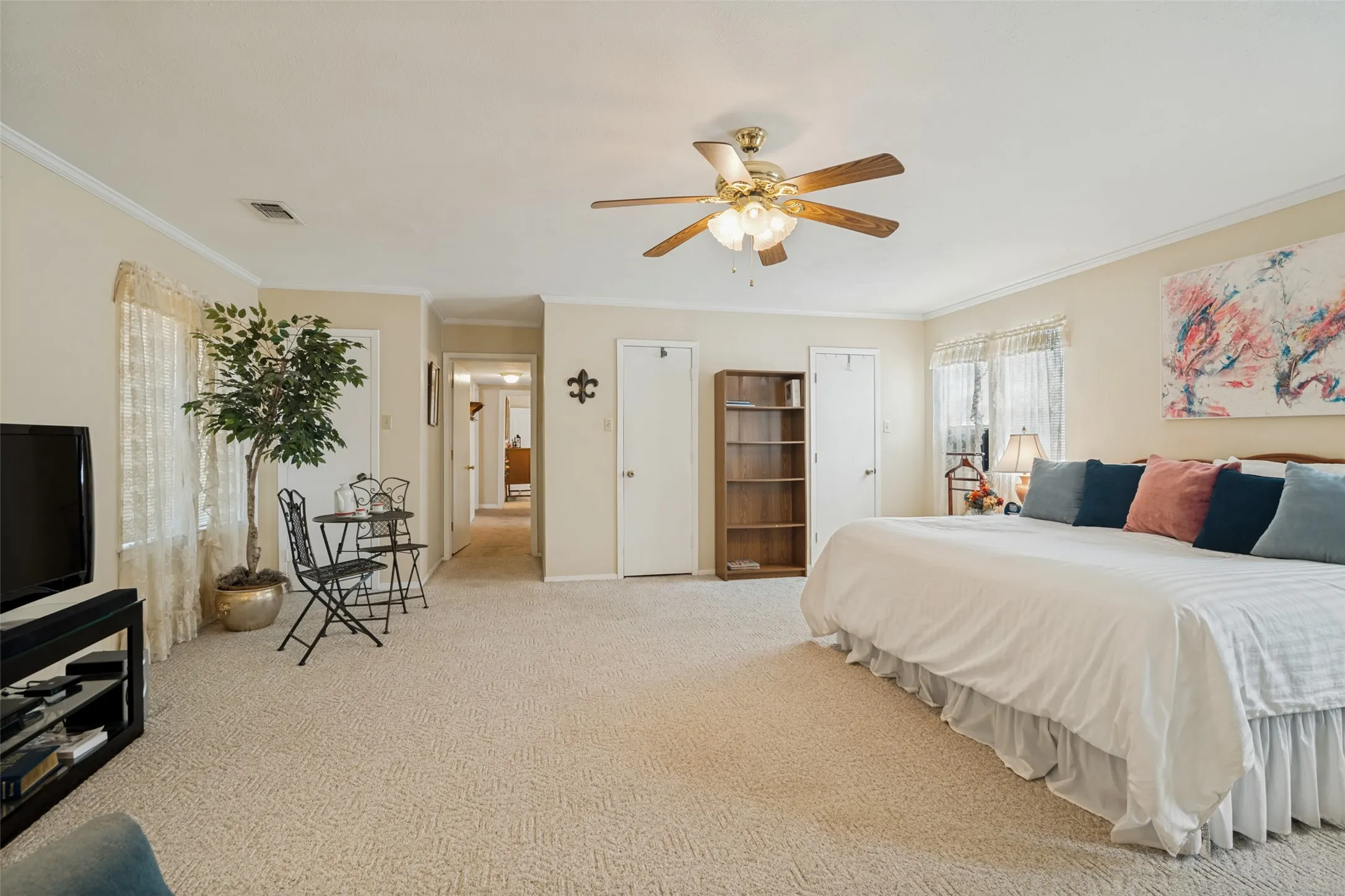 Large primary bedroom with garage entry and three closets