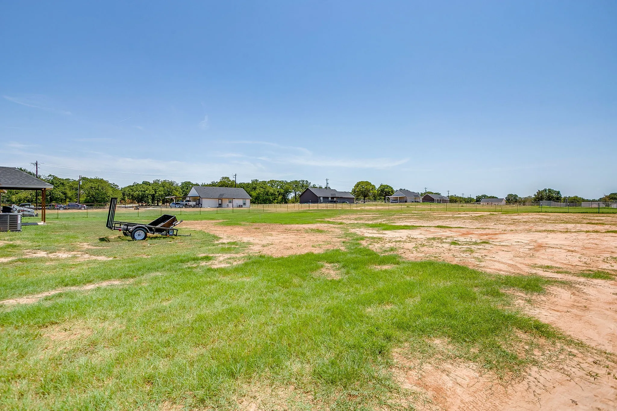 Expansive land area featuring a combination of natural grass and exposed earth
