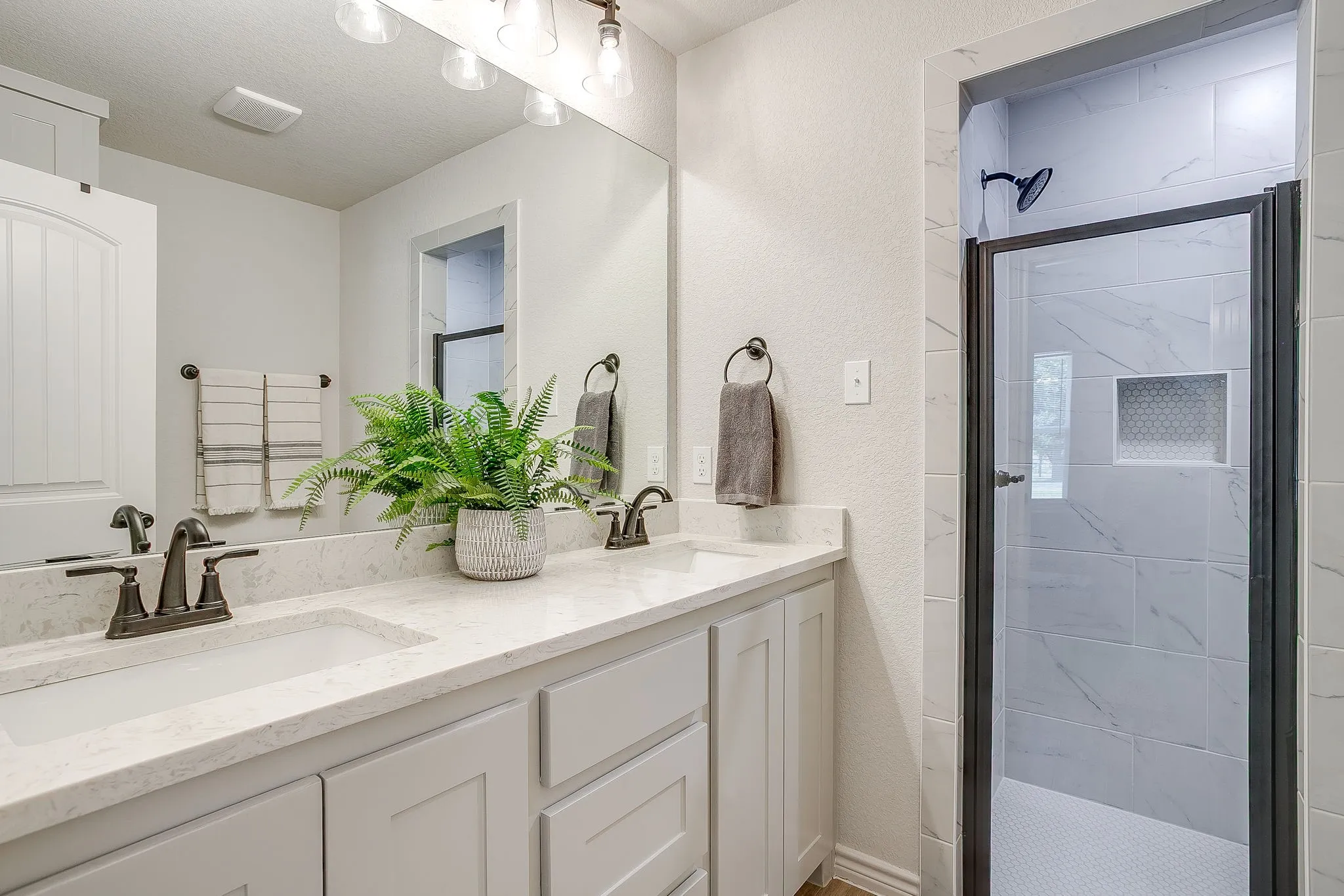Double vanity with undermount sinks and light-toned countertops