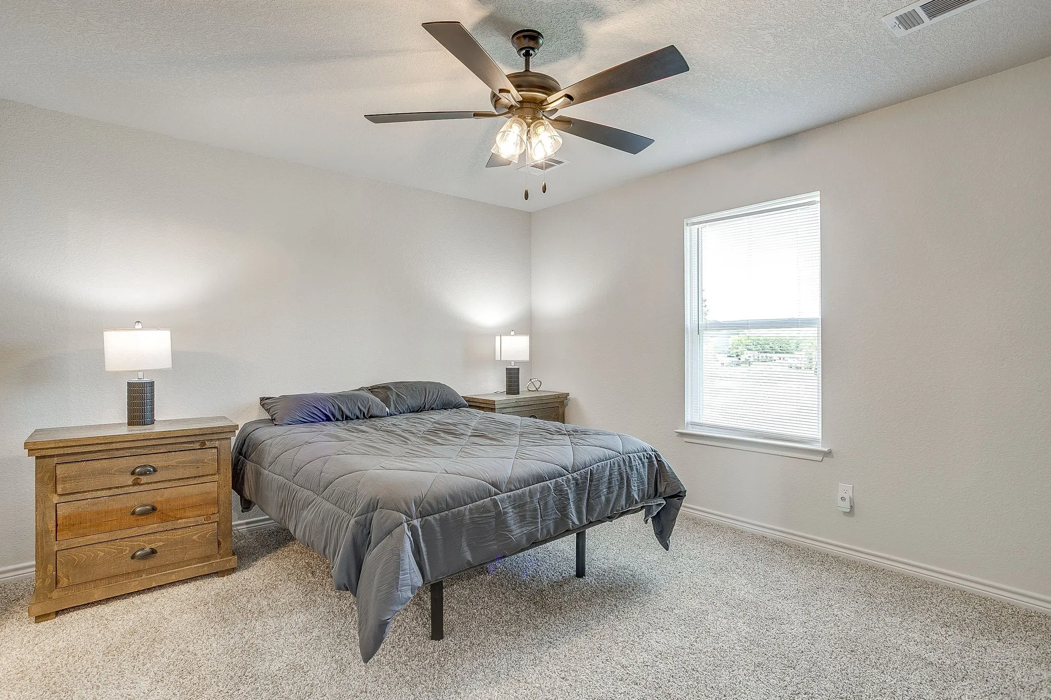 Recessed ceiling fan with integrated lighting, single window, wall-to-wall carpeting, light-toned walls, and white trim