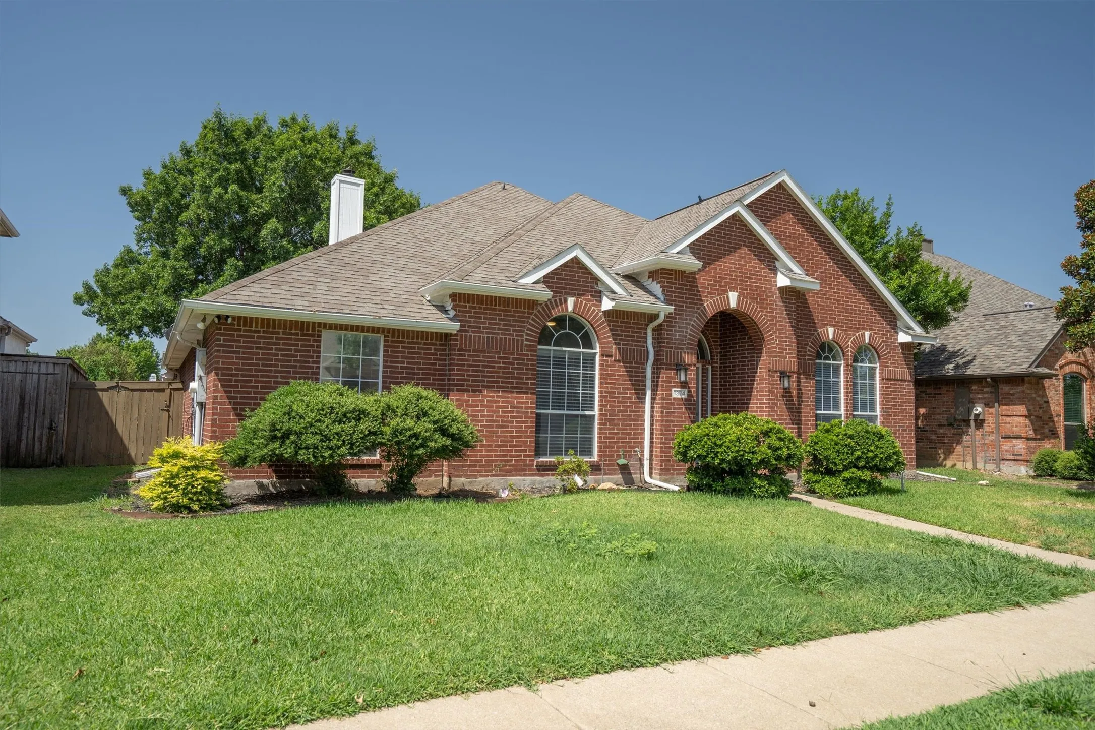 Brick exterior with arched window details and a prominent front entry
