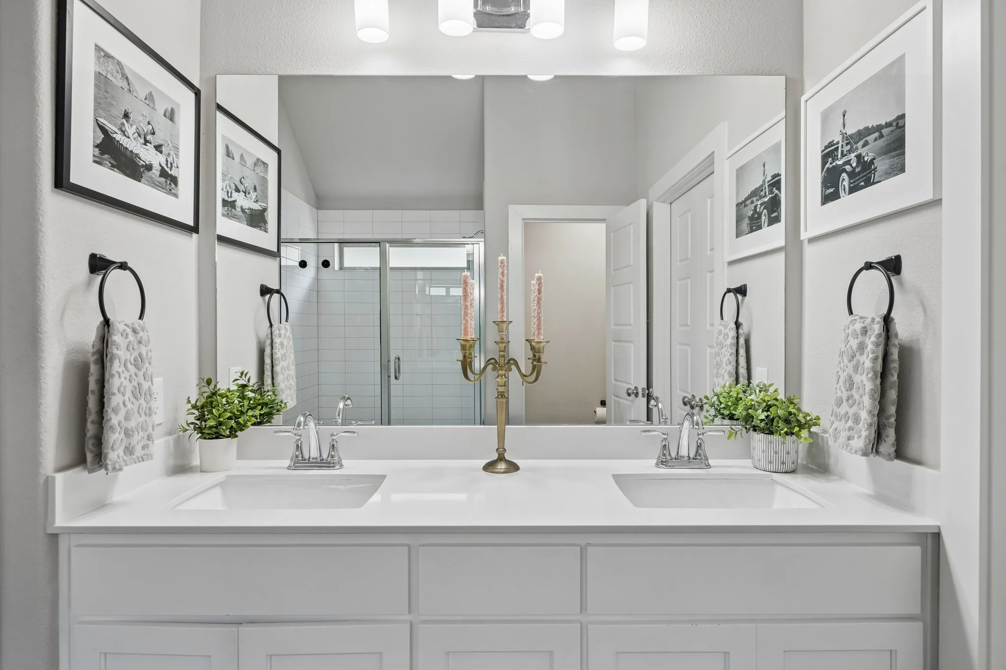 Dual vanity featuring undermount sinks, white cabinetry, and a spacious countertop