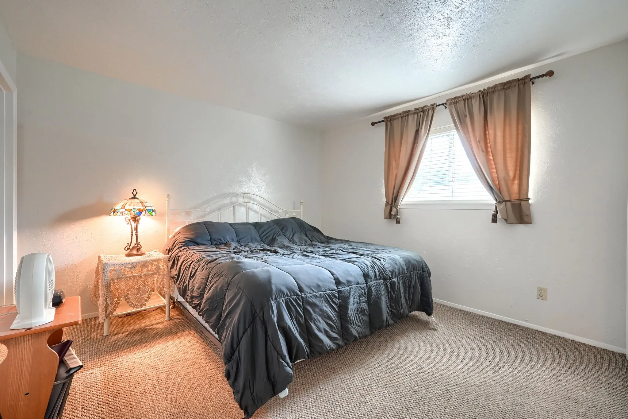 Bedroom featuring neutral-toned carpeting and white walls