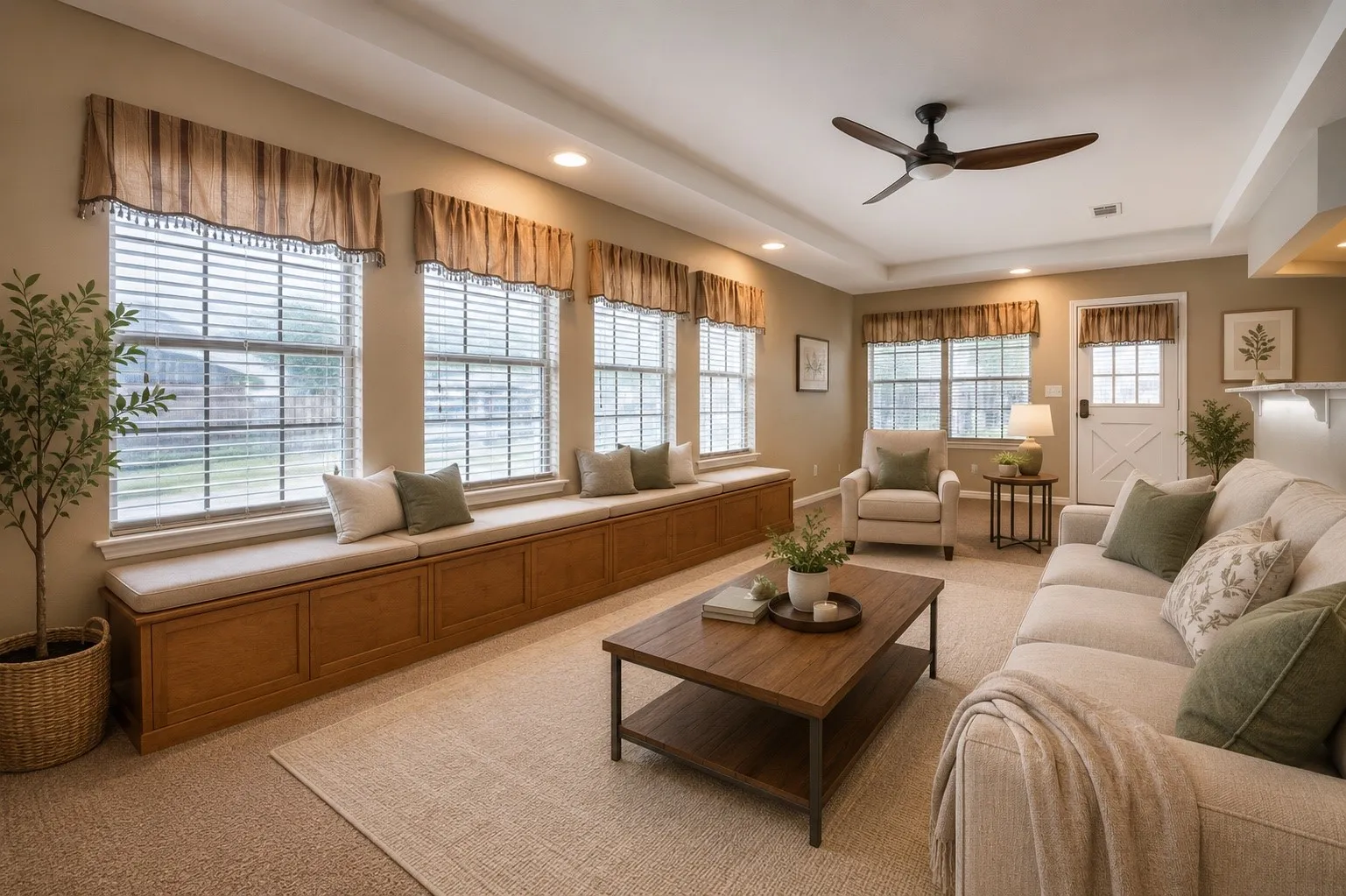 Spacious interior featuring a built-in window seat with storage, multiple windows with blinds, a ceiling fan, recessed lighting, and tray ceilings- AI- Layout Version 3