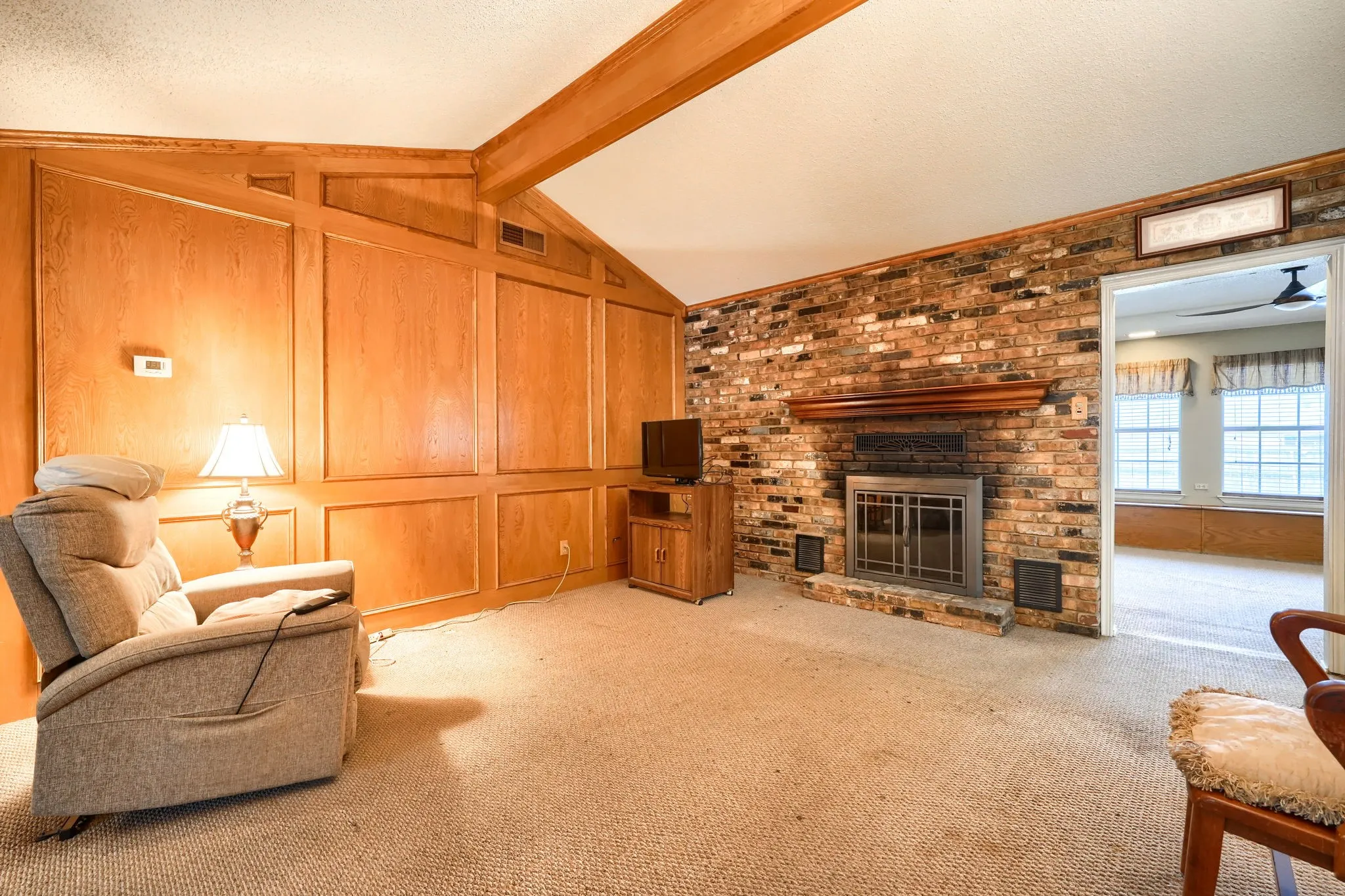 Brick fireplace with a wood mantle