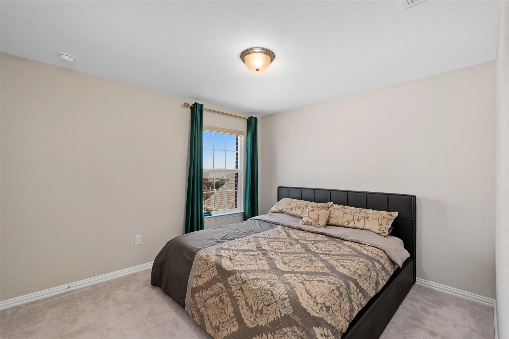 Carpeted room with a double-paned window, neutral wall paint, and a semi-flush mount ceiling light