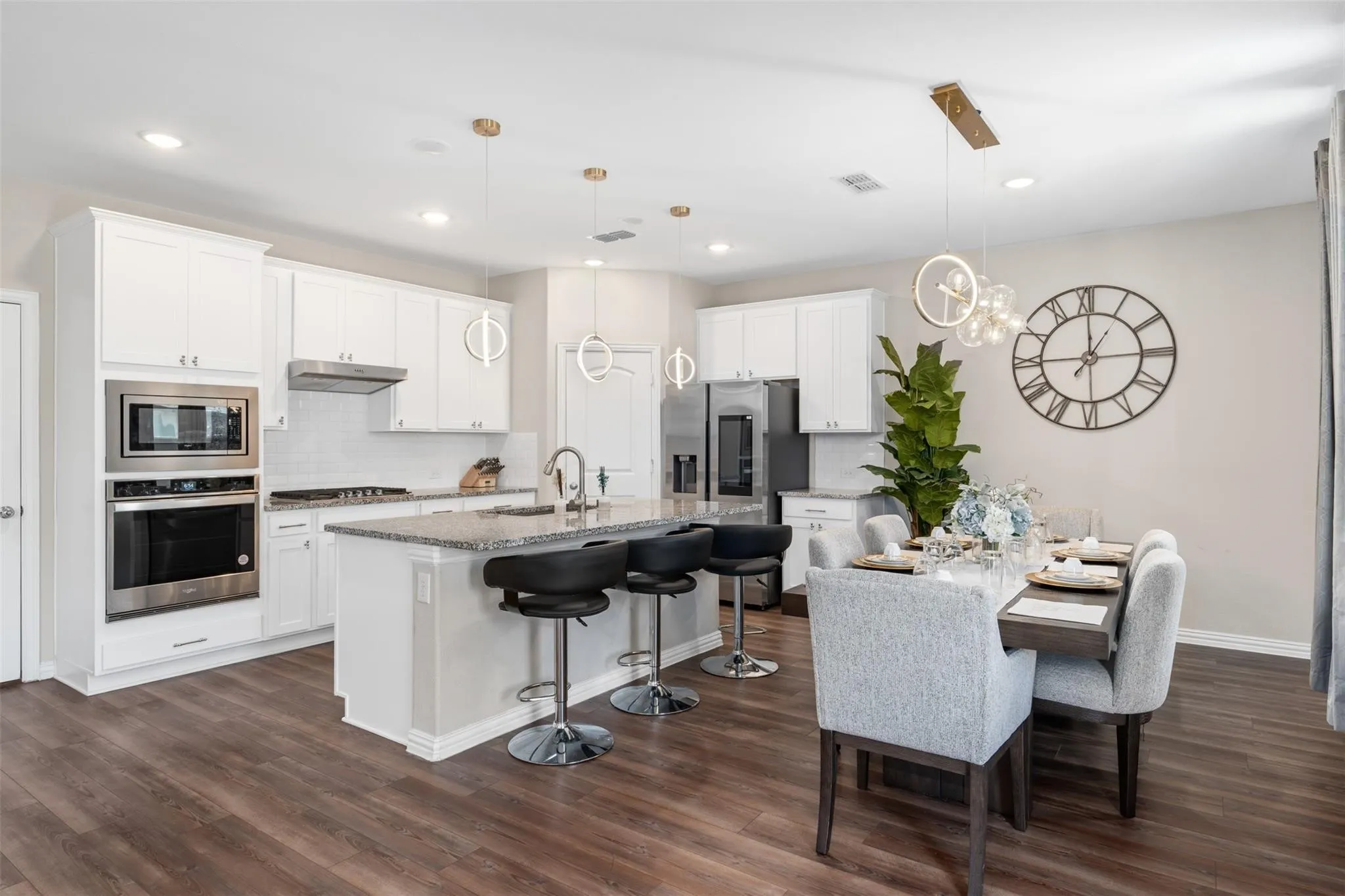 Open-concept kitchen and dining area featuring wood-finish flooring