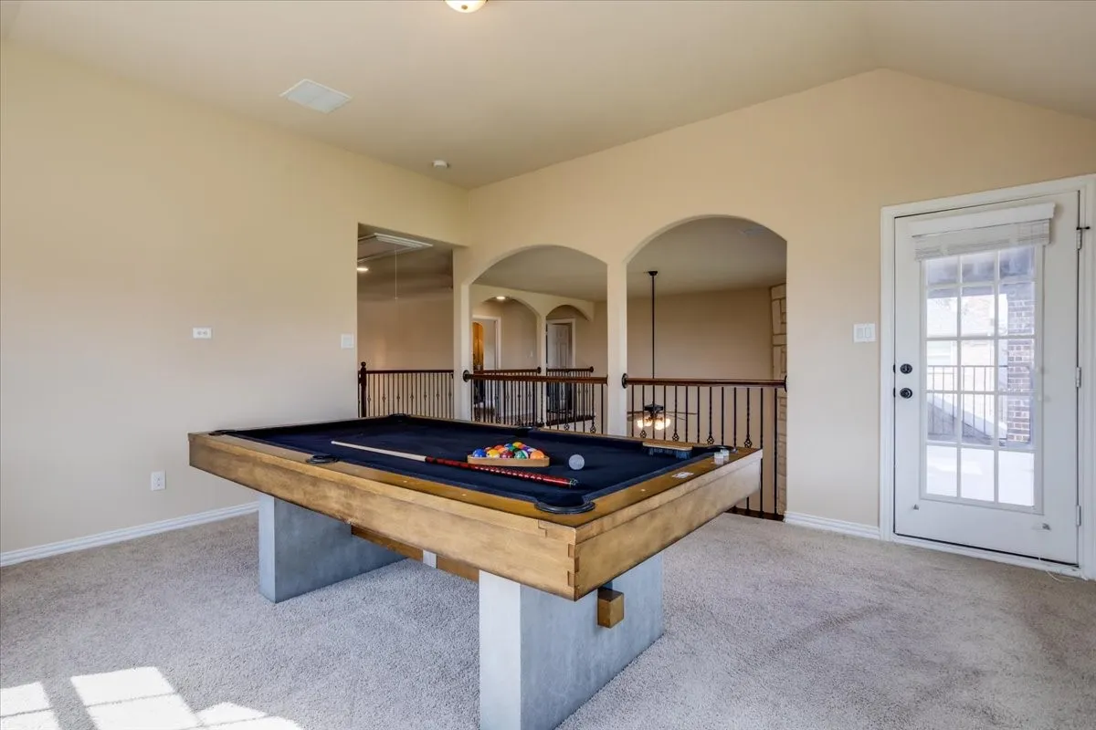 Rec room with light colored carpet, pool table, and arched walkways