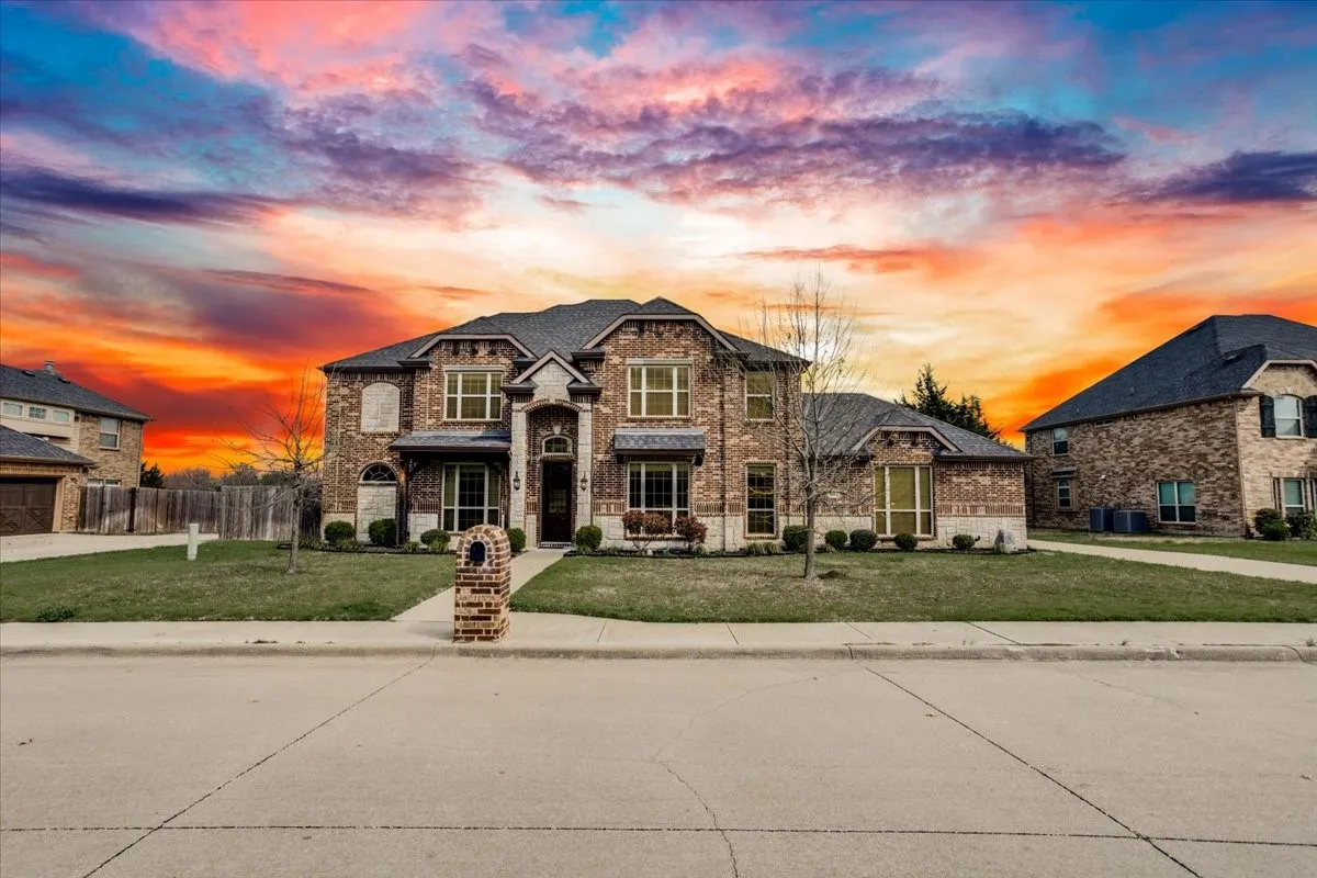 View of front of home featuring brick siding and stone siding