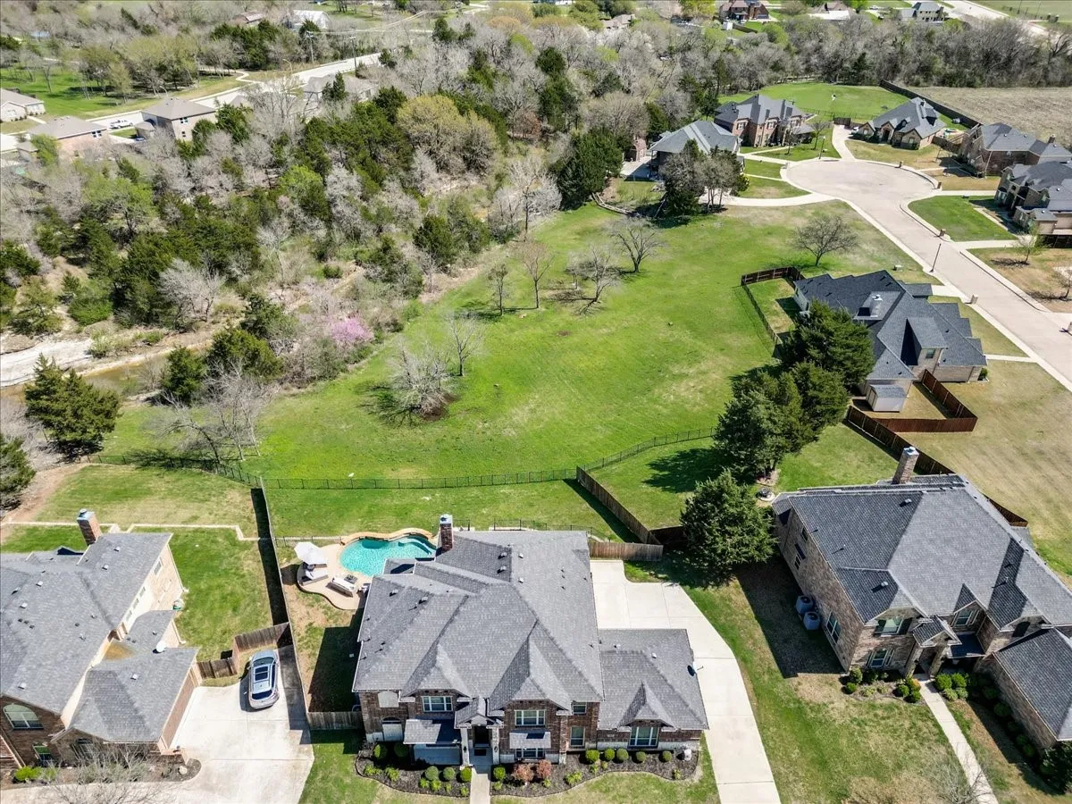 Aerial view of residential area featuring a pool