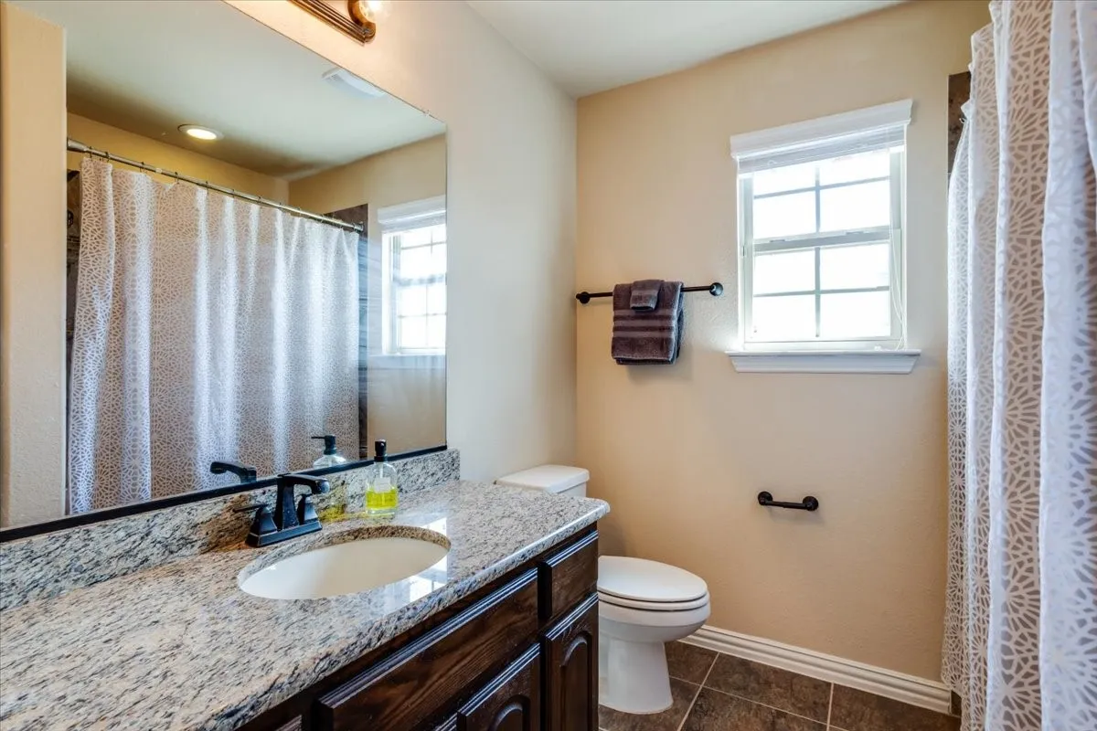 Full bath with vanity and a shower with curtain