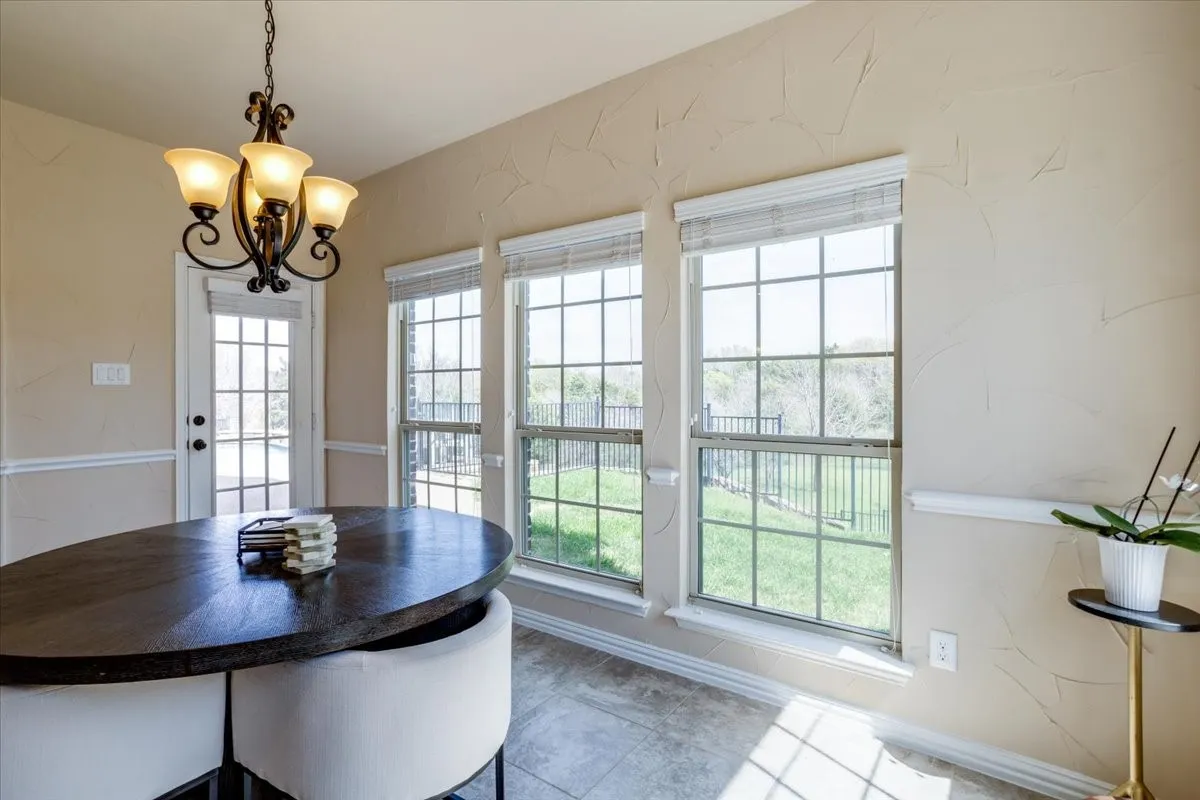 Dining room featuring a chandelier and baseboards