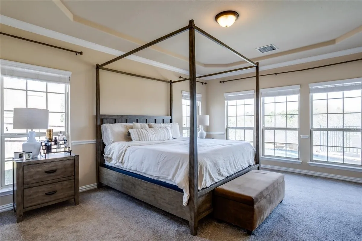 Carpeted bedroom featuring baseboards