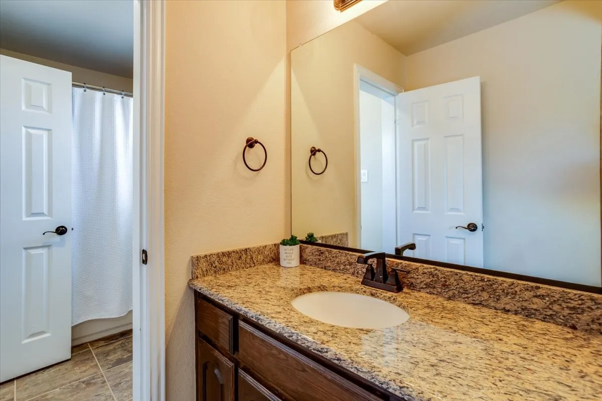 Full bath with vanity and a shower with curtain