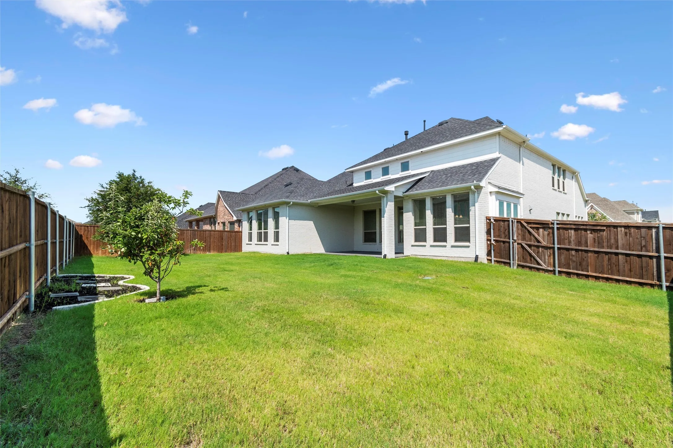 Back of property featuring a yard